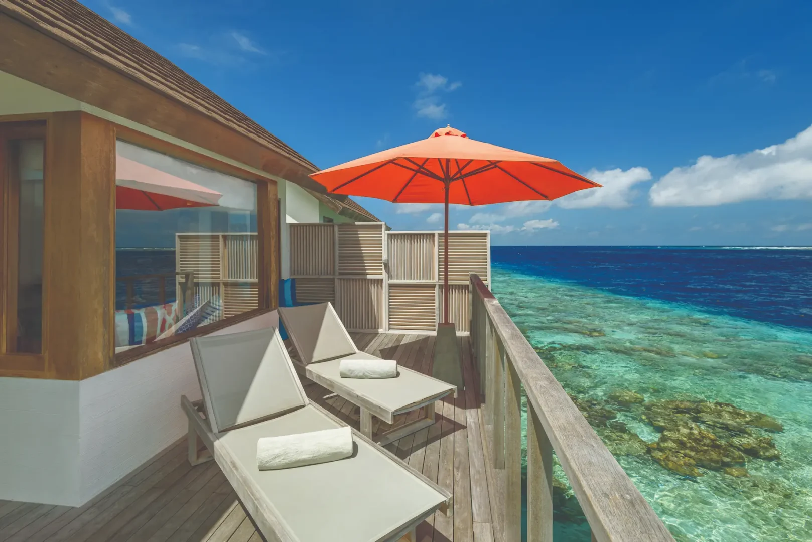 oblu select sangeli maldives water villa exterior deck view tranquil overwater deck with lagoon views warm wood textures and serene tropical ambience