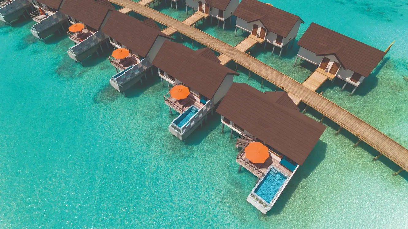 oblu select sangeli maldives water villas jetty aerial elevated aerial view of overwater villa jetty surrounded by turquoise lagoon and serene tropical ambience
