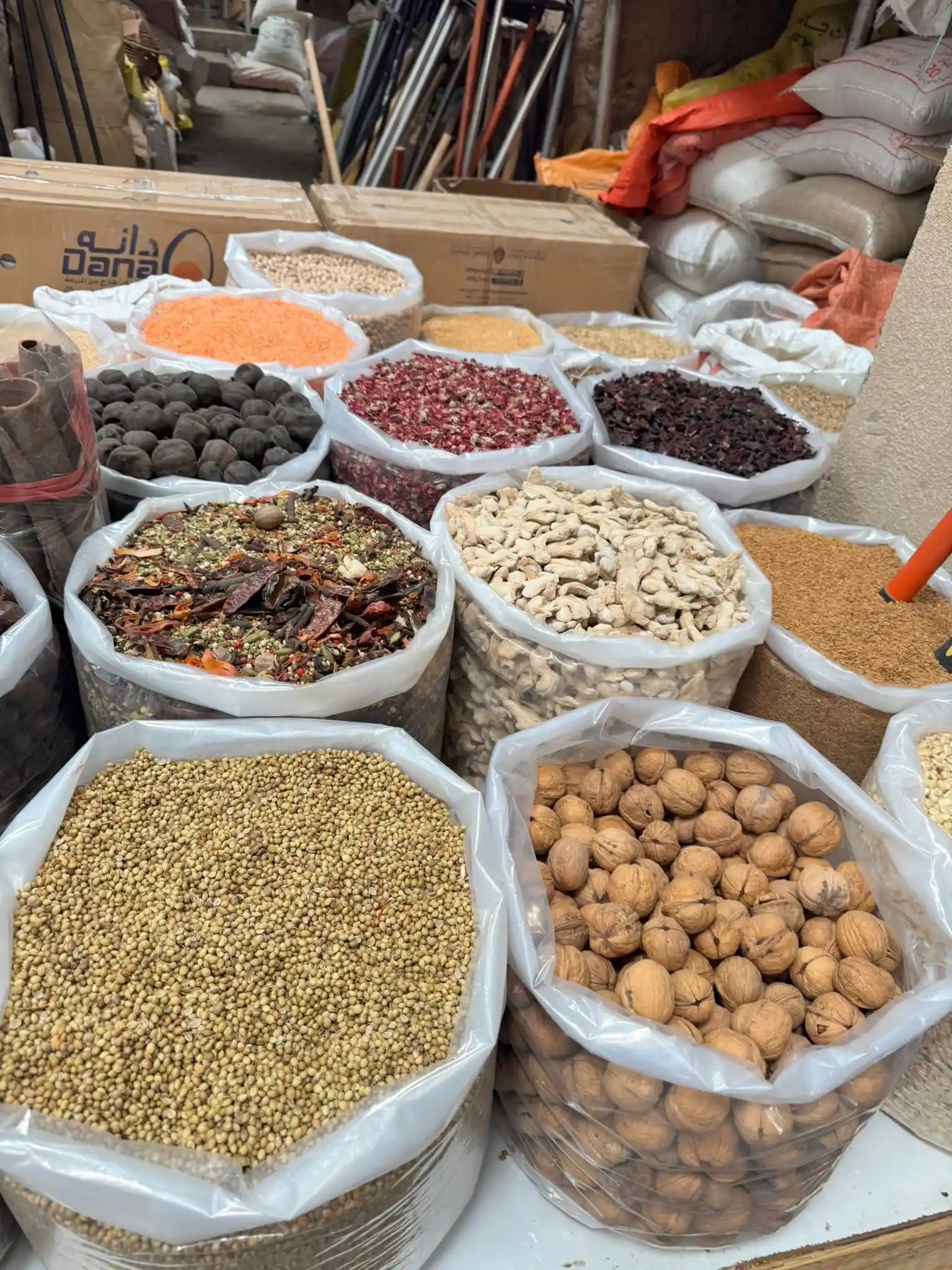 oman spices market with colorful heaps of saffron, cardamom, cinnamon, and other aromatic spices displayed in traditional baskets and containers