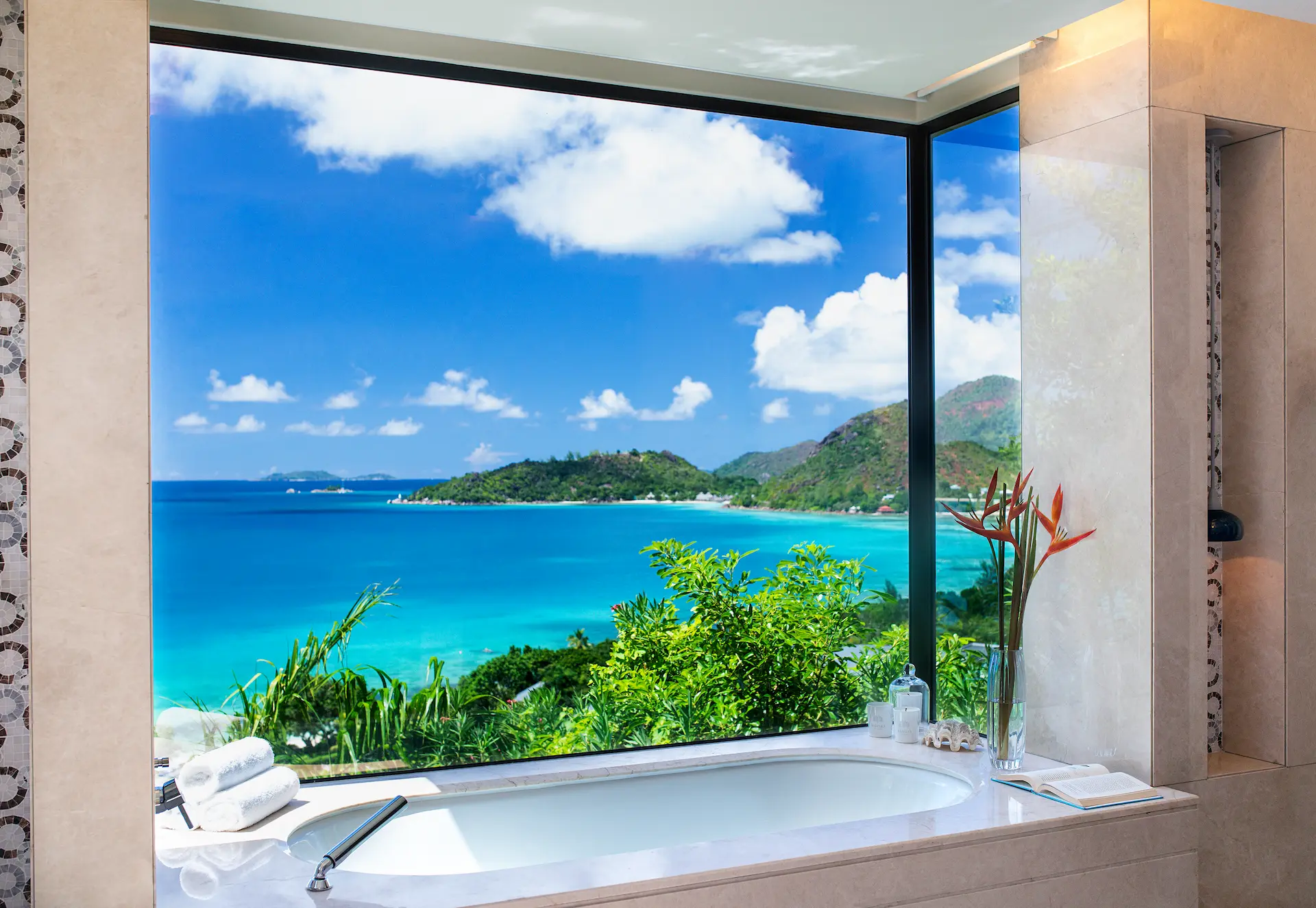 bathroom with bathtub in panoramic pool villa in seychelles overlooking private pool and turquoise ocean