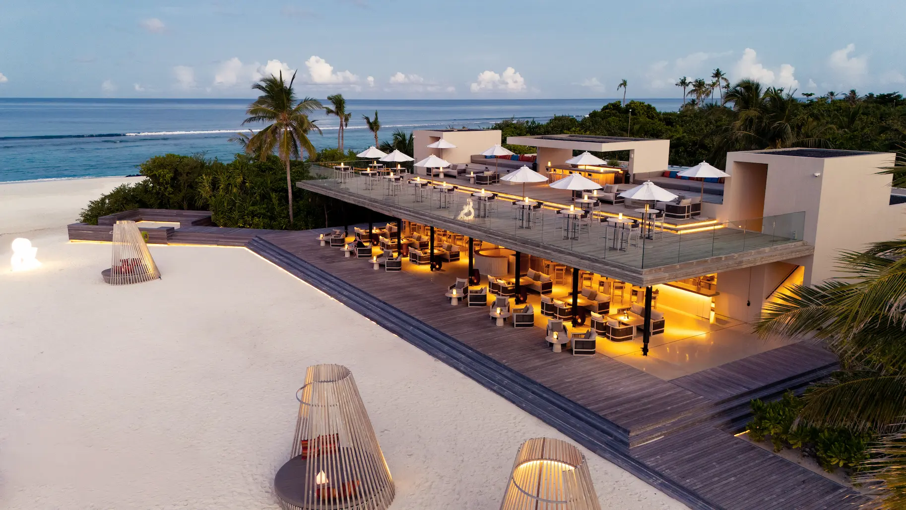 raaya by atmosphere raa atoll maldives aerial ampersand sunset with a serene tropical horizon
