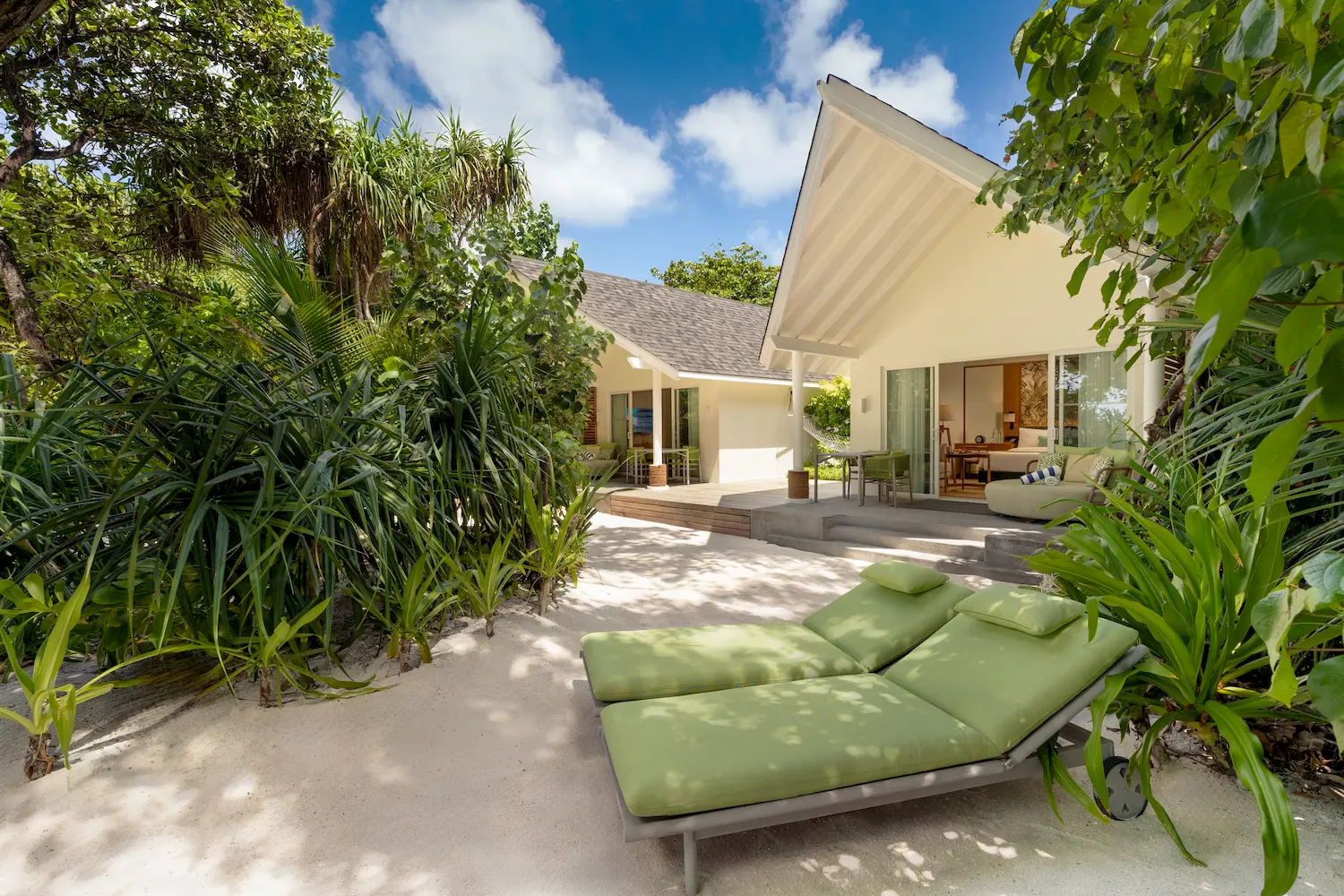 raaya by atmosphere raa atoll maldives family beach villa exterior with a serene tropical setting