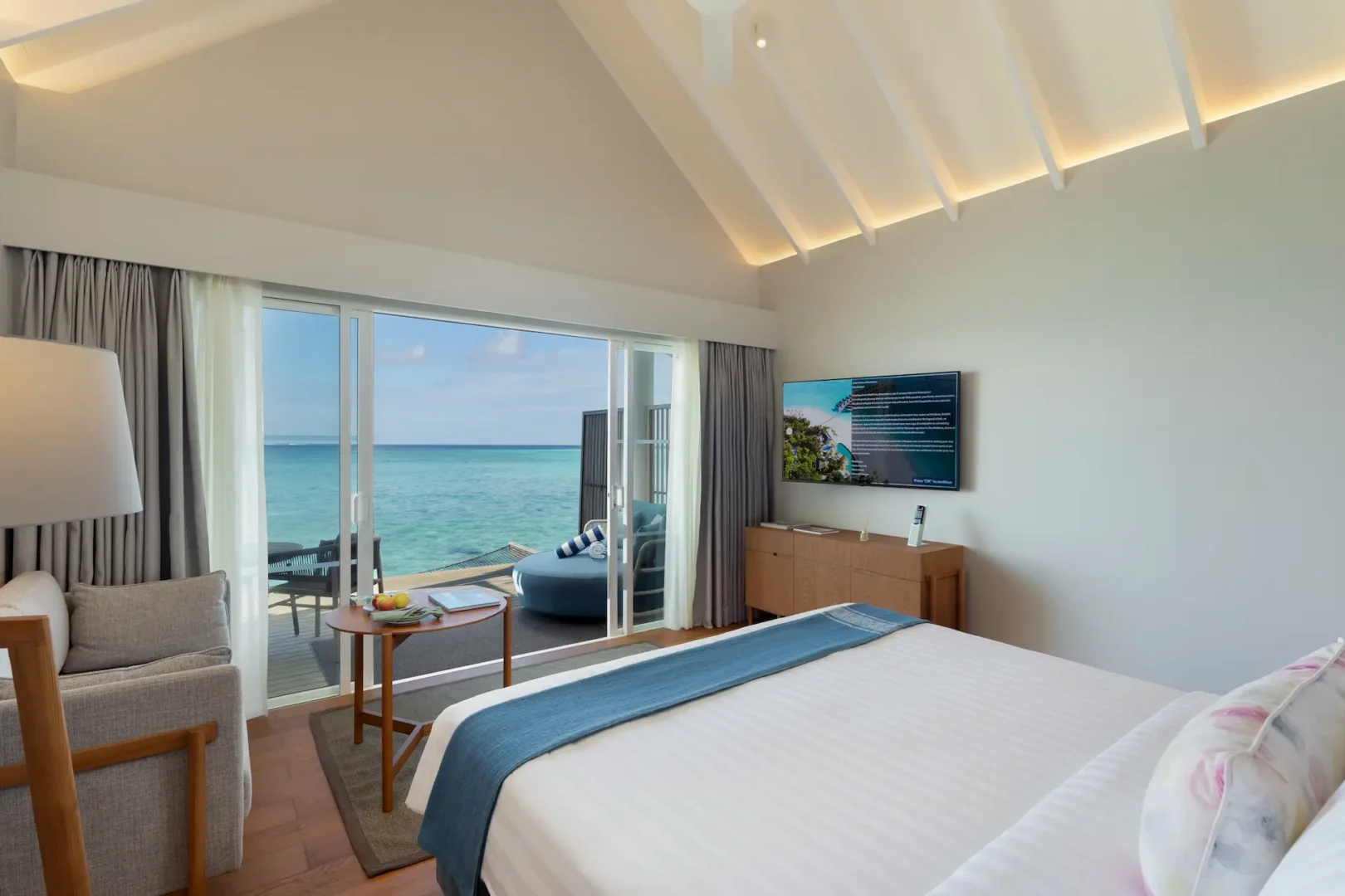raaya by atmosphere raa atoll maldives water villa bedroom terrace with calm ocean atmosphere