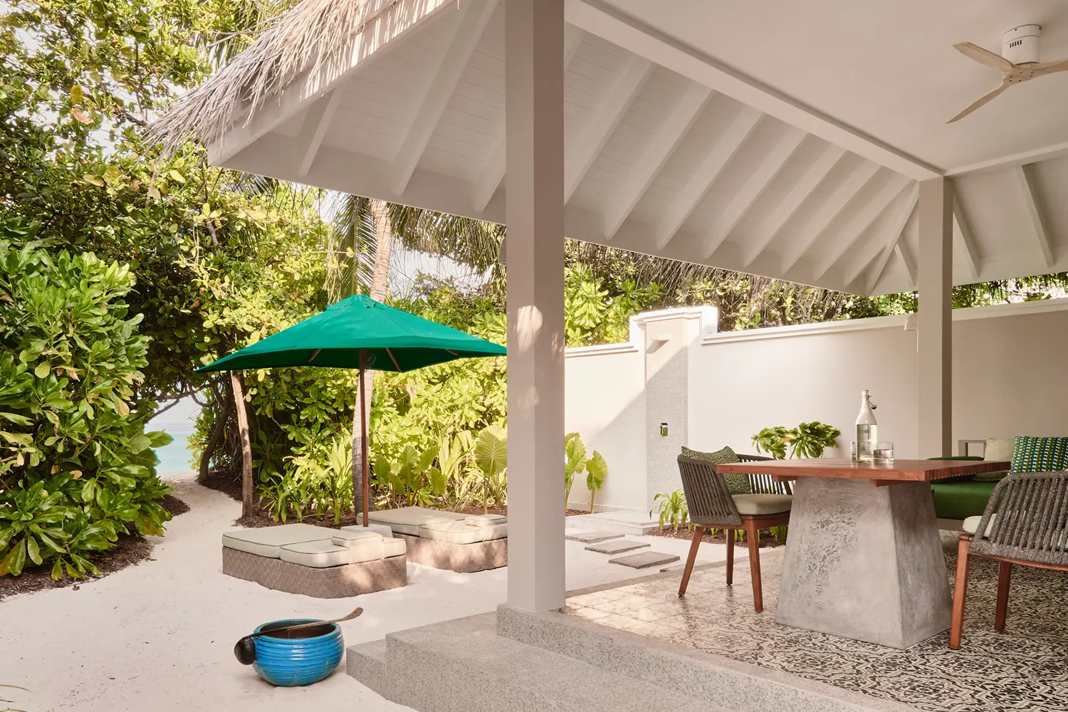 seaside finolhu beach villa outdoor terrace two bedroom interconnecting beach villa featuring private lounging space tropical greenery and serene maldives island ambience