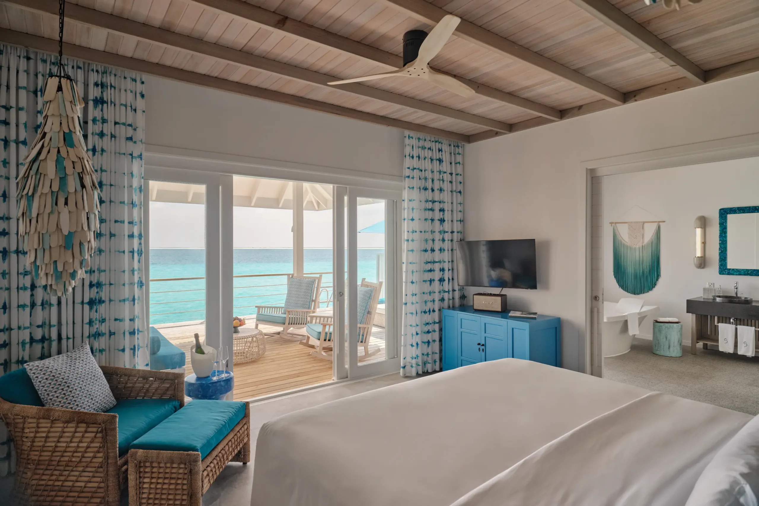 seaside finolhu lagoon villa bedroom featuring elegant coastal design soft natural textures and serene maldives lagoon views