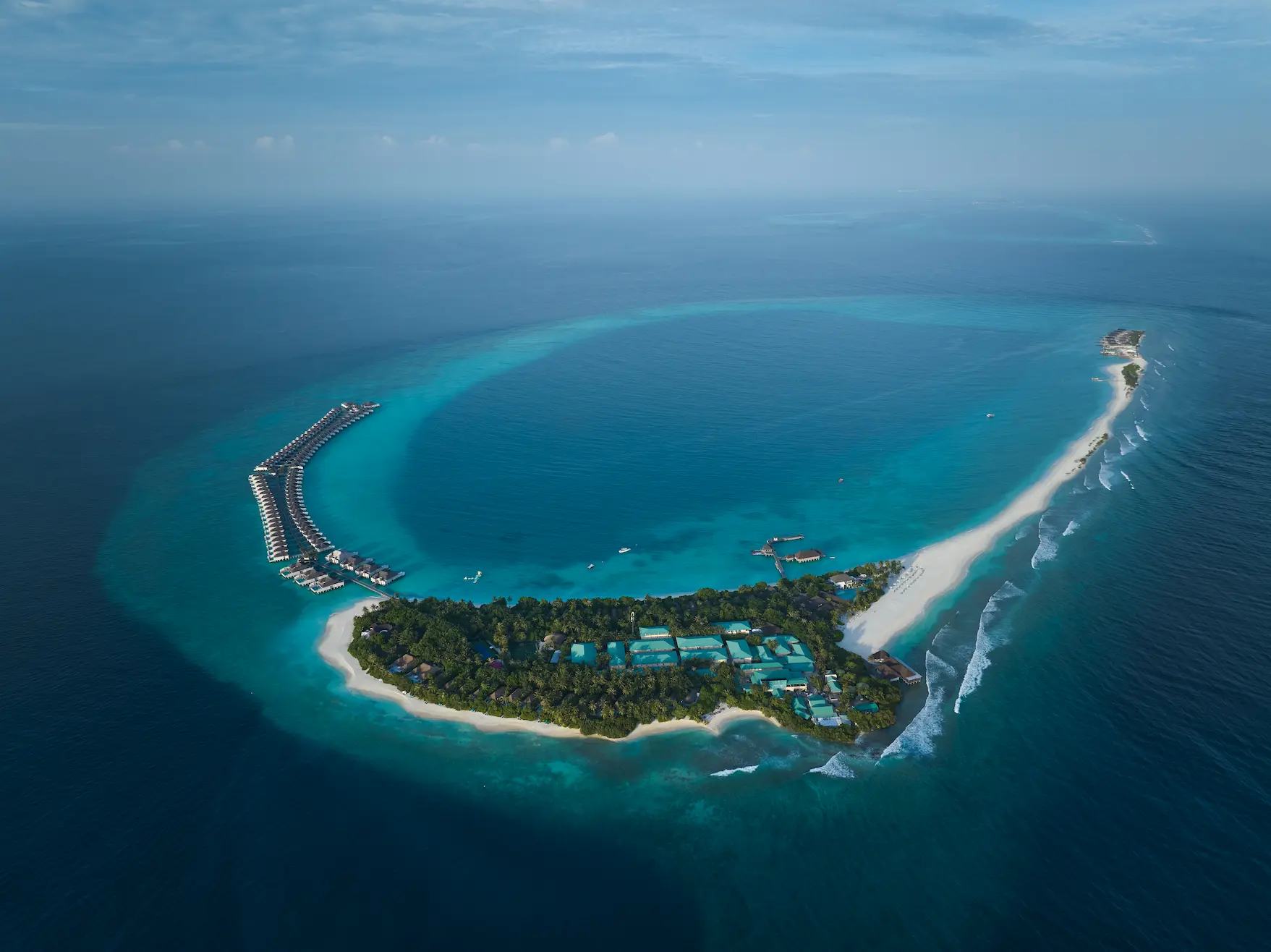 seaside finolhu maldives aerial overview sweeping birdseye perspective of the island with vibrant turquoise waters and soft white sand