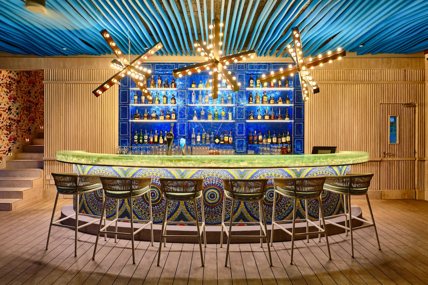 seaside finolhu maldives beach club bar relaxed beachfront bar setting with warm natural textures and a vibrant island atmosphere