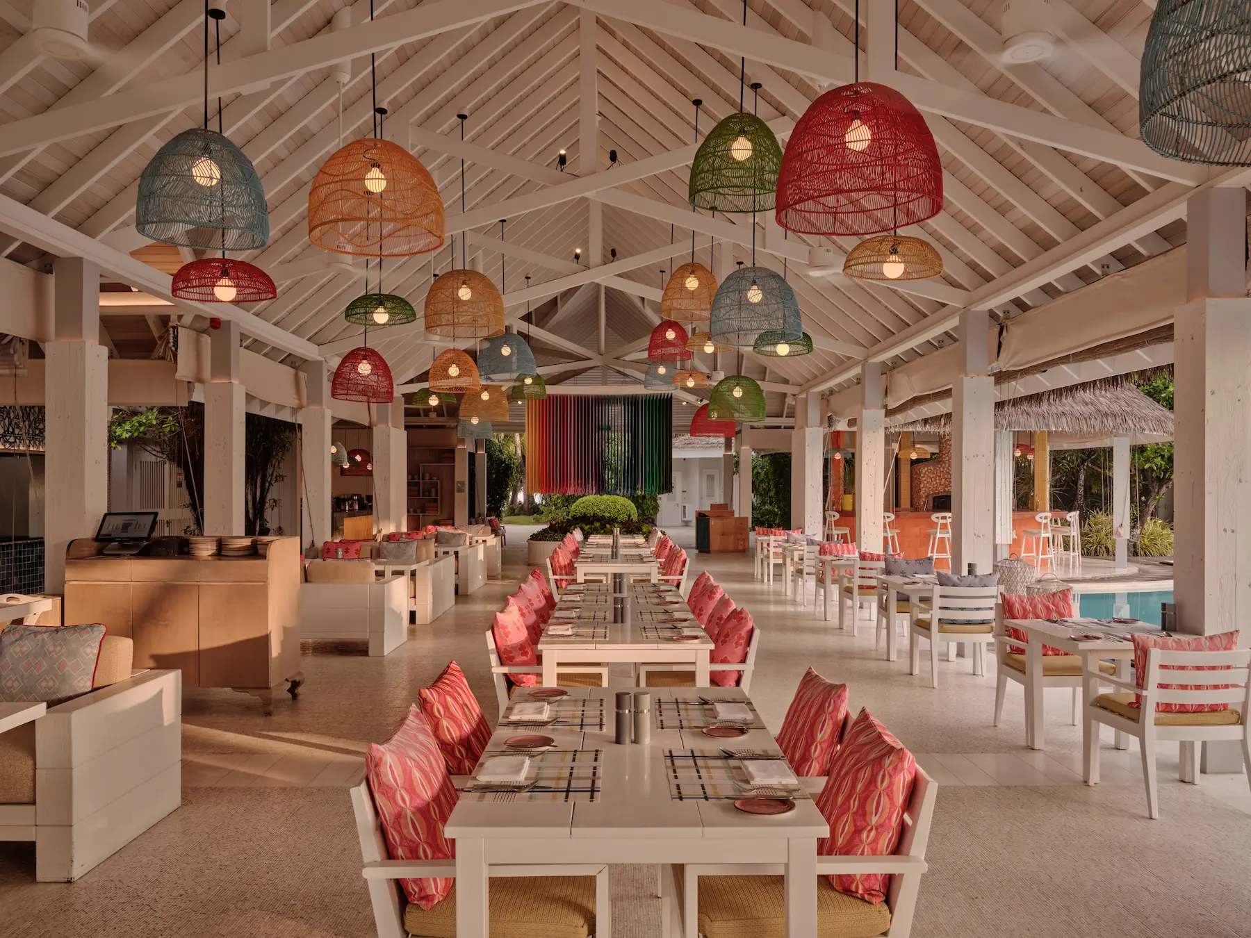 seaside finolhu maldives beach kitchen indoor seating area refined indoor dining space with warm natural textures and relaxed coastal ambiance