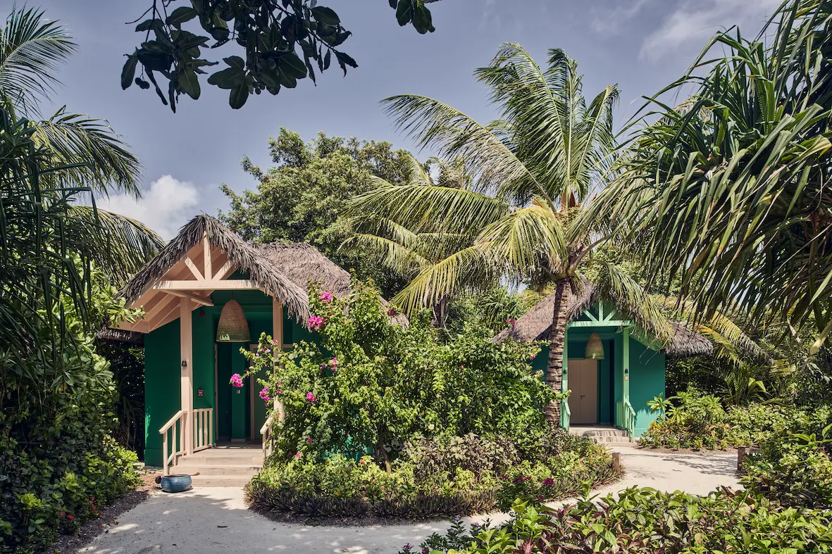 seaside finolhu maldives fehi spa walkway serene garden pathway leading to the spa with soft natural greenery and calming island ambiance