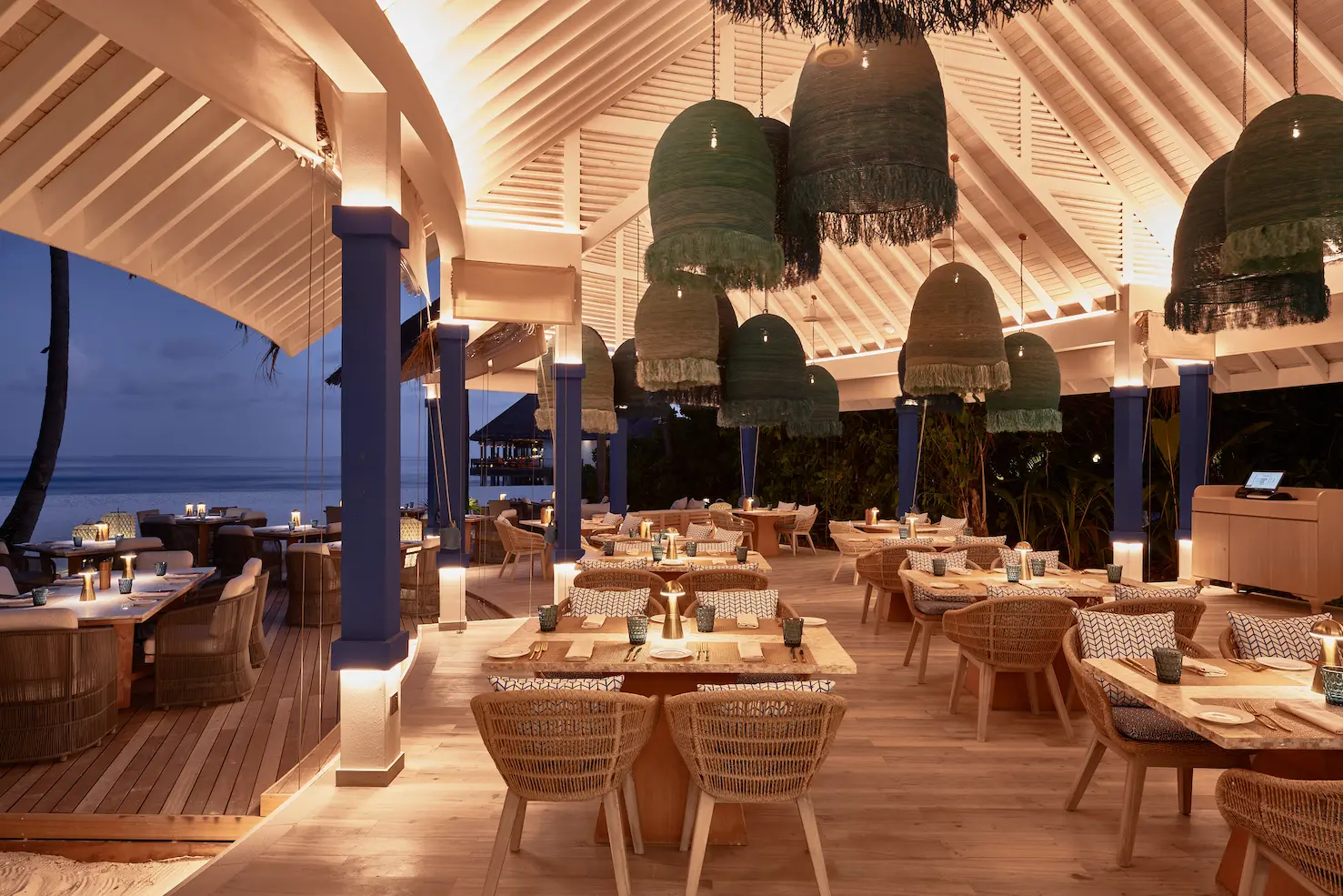 seaside finolhu maldives indoor seating area elegant lounge style seating with warm textures and a relaxed coastal atmosphere