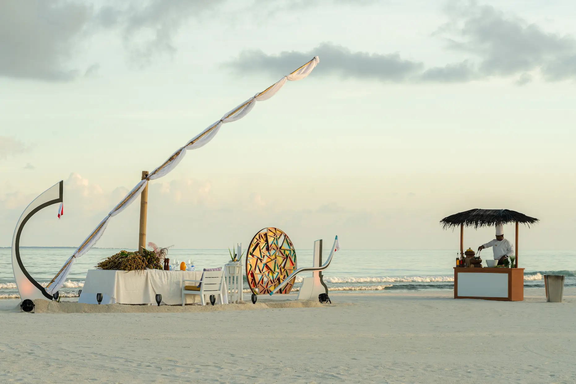 seaside finolhu maldives kaleidoscope and dhoni dining set up elegant dining arrangement blending coastal textures with refined island ambiance