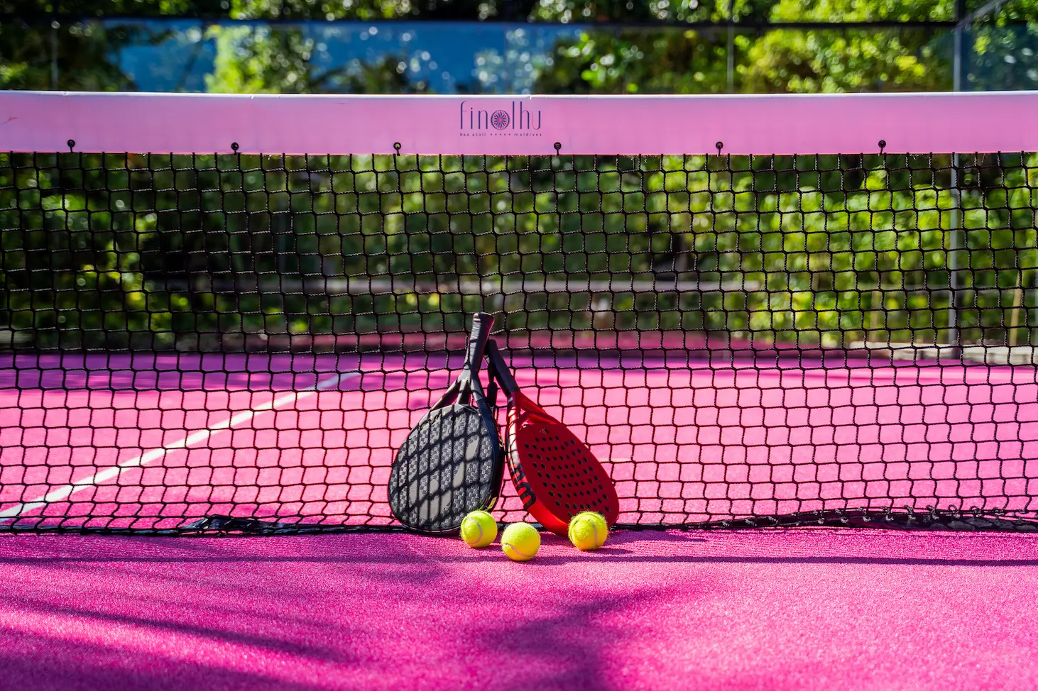 seaside finolhu maldives padel tennis court modern outdoor padel court surrounded by bright island greenery and soft natural light