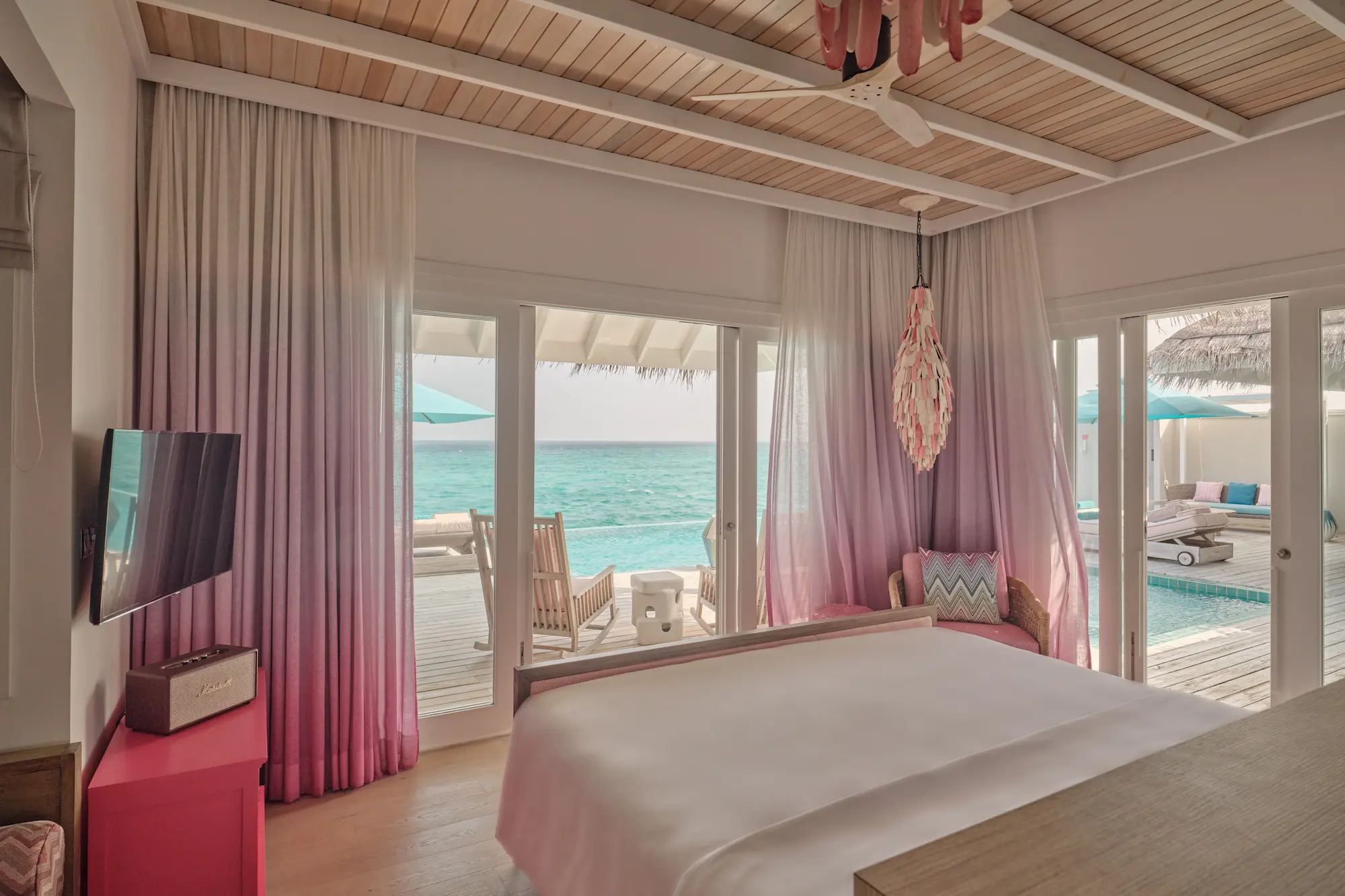 seaside finolhu maldives rockstar two bedroom master bedroom area refined oceanfront suite with warm natural textures and a spacious relaxing ambiance
