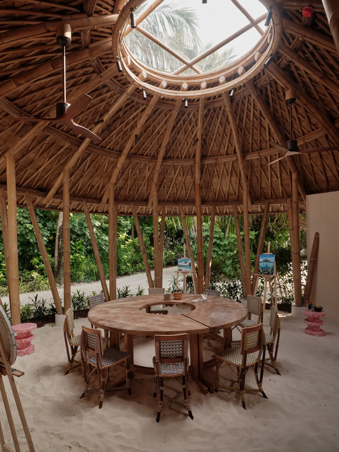 seaside finolhu maldives round table section art lab creative indoor studio space with a refined round table setup and warm natural textures