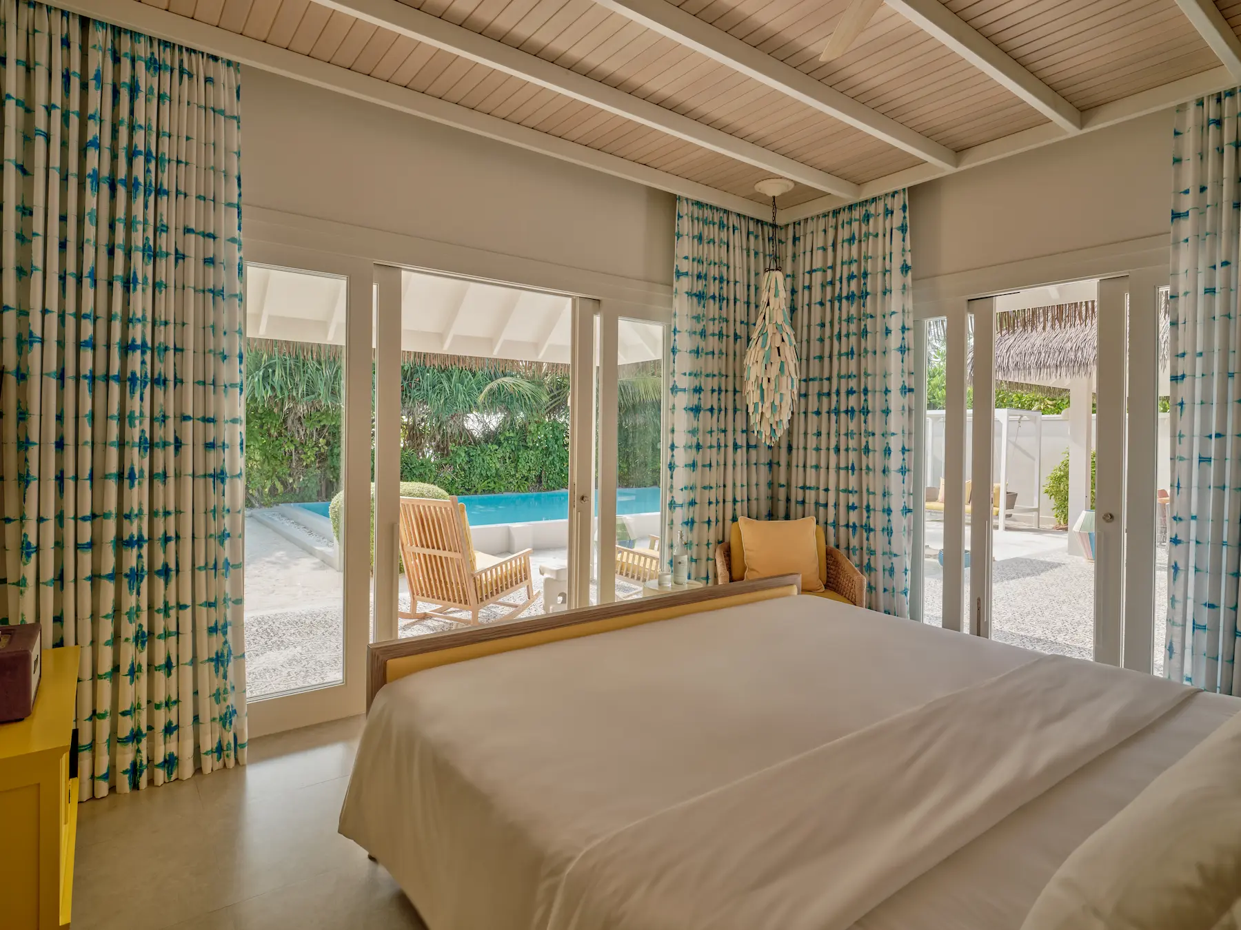 seaside finolhu maldives two bedroom beach pool villa master bedroom serene beachfront suite with soft natural textures and gentle ocean light