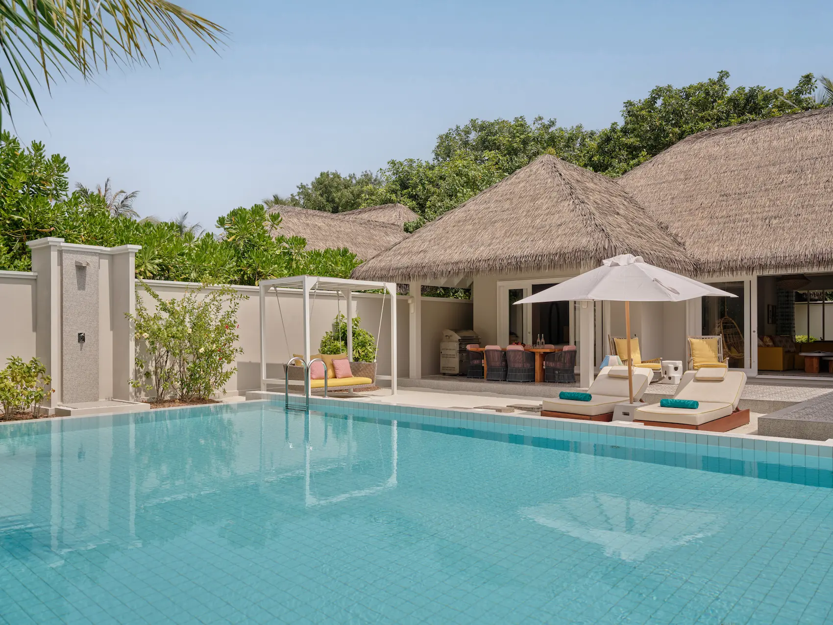 seaside finolhu maldives two bedroom beach pool villa pool terrace area peaceful outdoor lounging space with private pool and soft coastal greenery
