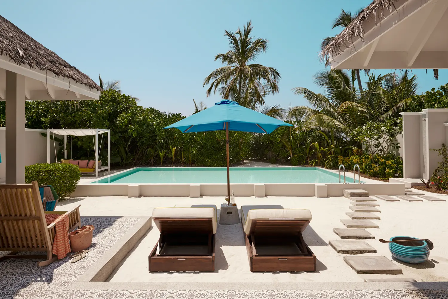 seaside finolhu maldives two bedroom beach villa outdoor area tranquil private outdoor space framed by lush greenery and soft natural light
