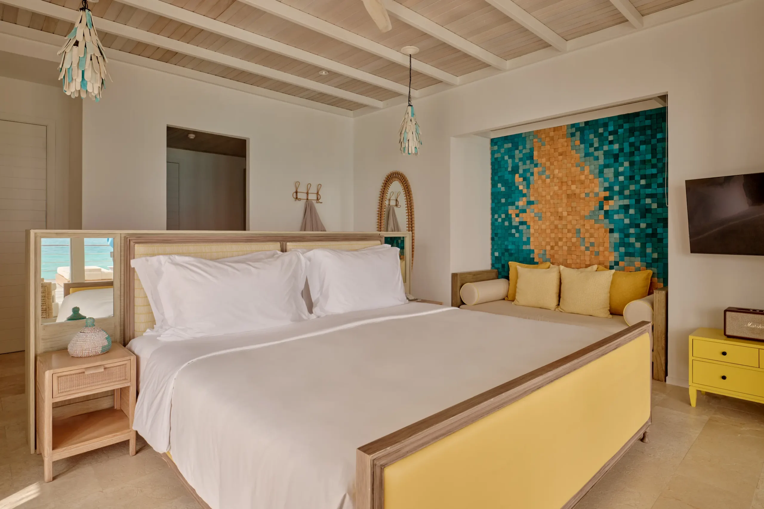 seaside finolhu maldives two bedroom water villa with pool refined master bedroom with tranquil lagoon views and soft natural light
