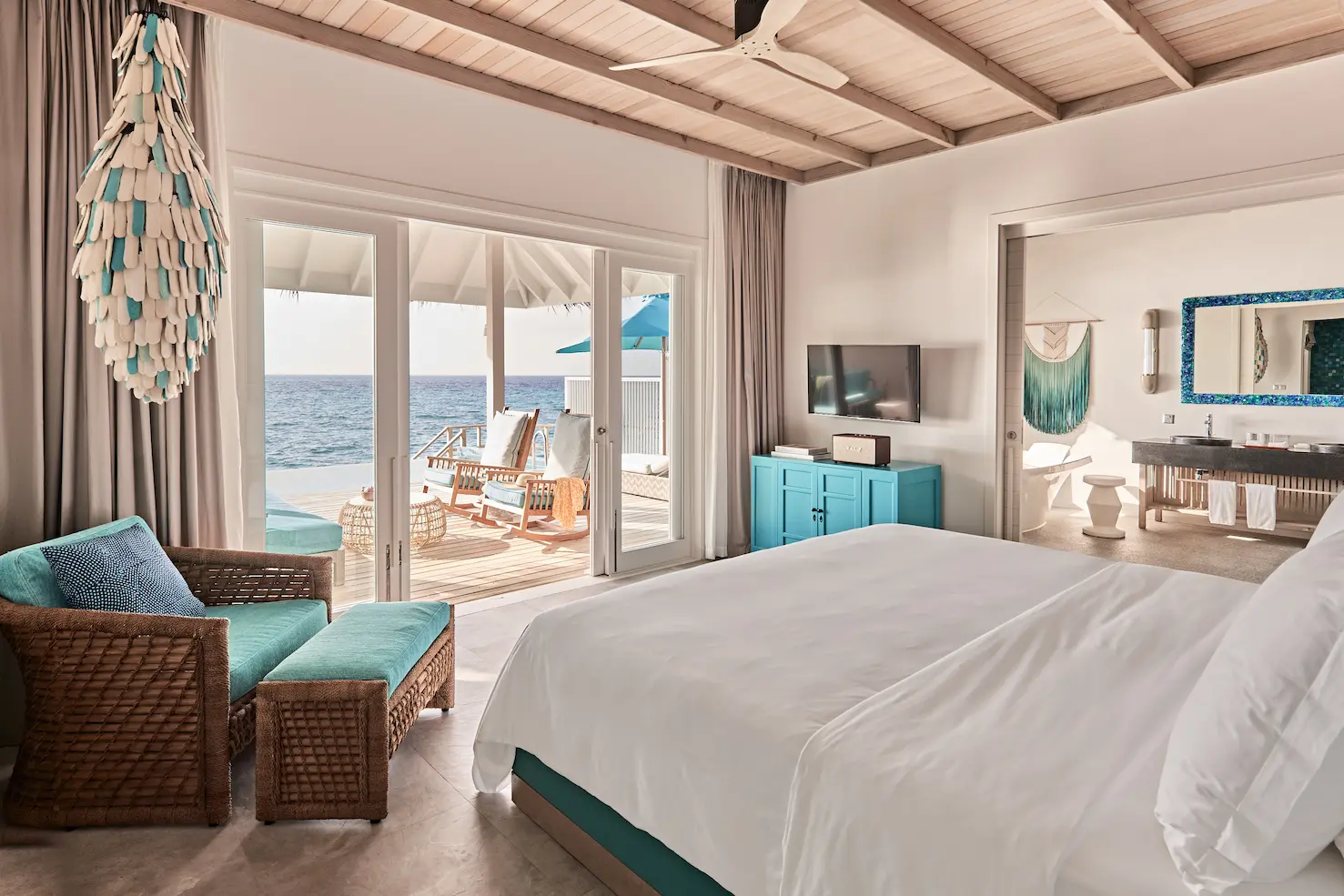 seaside finolhu ocean pool villa bedroom and bathroom featuring elegant coastal design natural textures and serene maldives ocean views