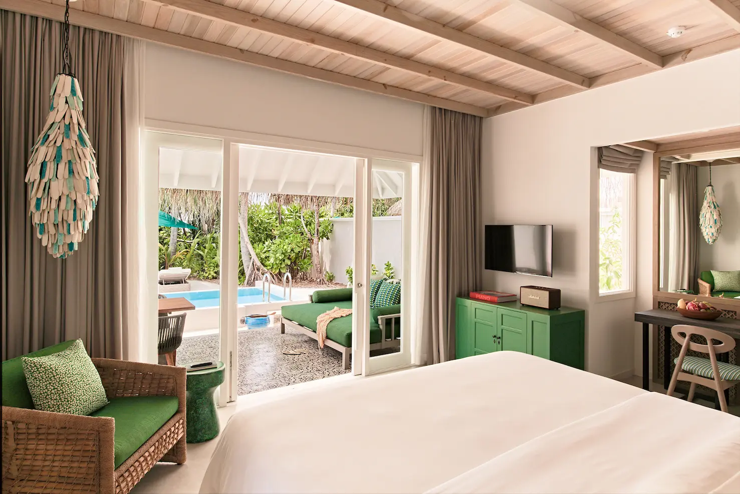 seaside finolhu private pool villa bedroom featuring elegant coastal design natural textures and serene maldives island ambience