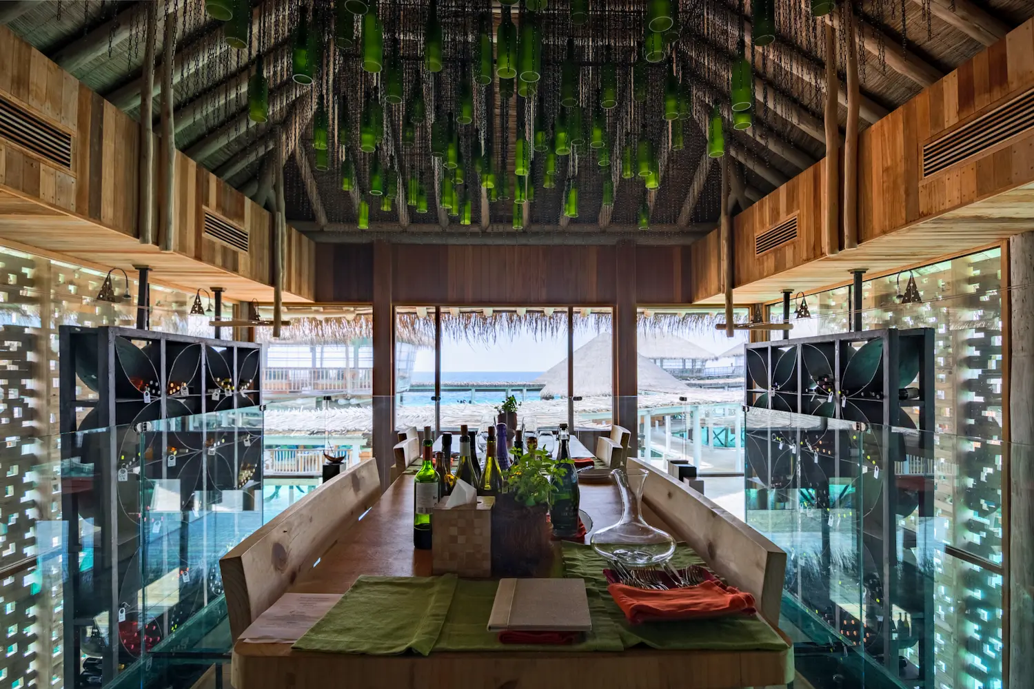 six senses laamu maldives altitude cellar with warm ambient lighting natural wood interiors and a serene refined barefoot luxury wine tasting atmosphere