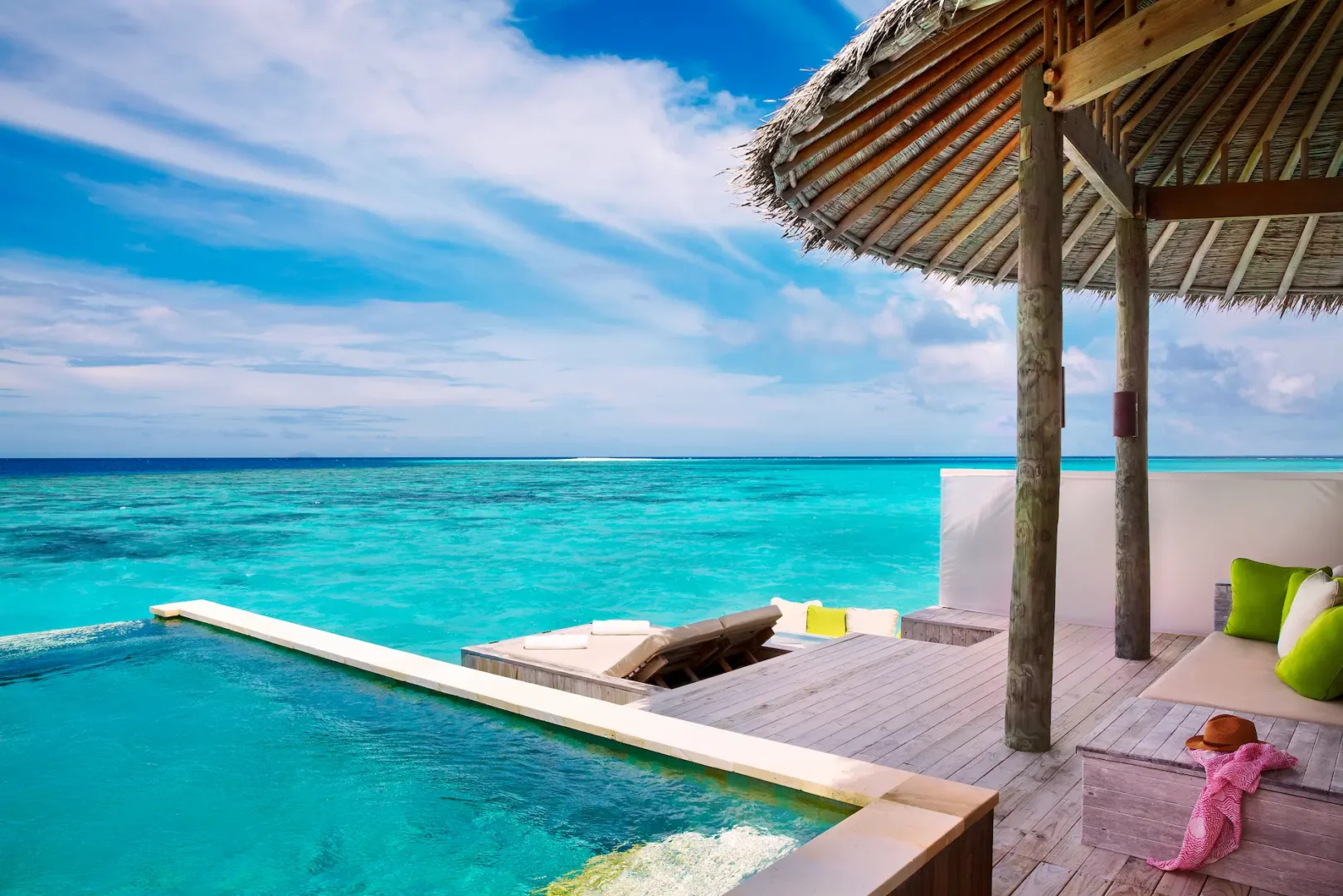 six senses laamu maldives laamu water villa with pool terrace overlooking the lagoon with natural wood styling and a calm elevated barefoot luxury atmosphere
