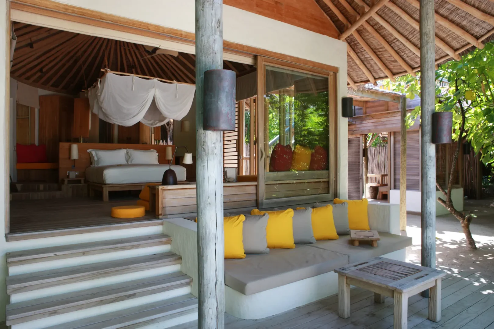 six senses laamu maldives lagoon beach villa with pool surrounded by tropical greenery natural wood design and a serene elevated barefoot luxury atmosphere