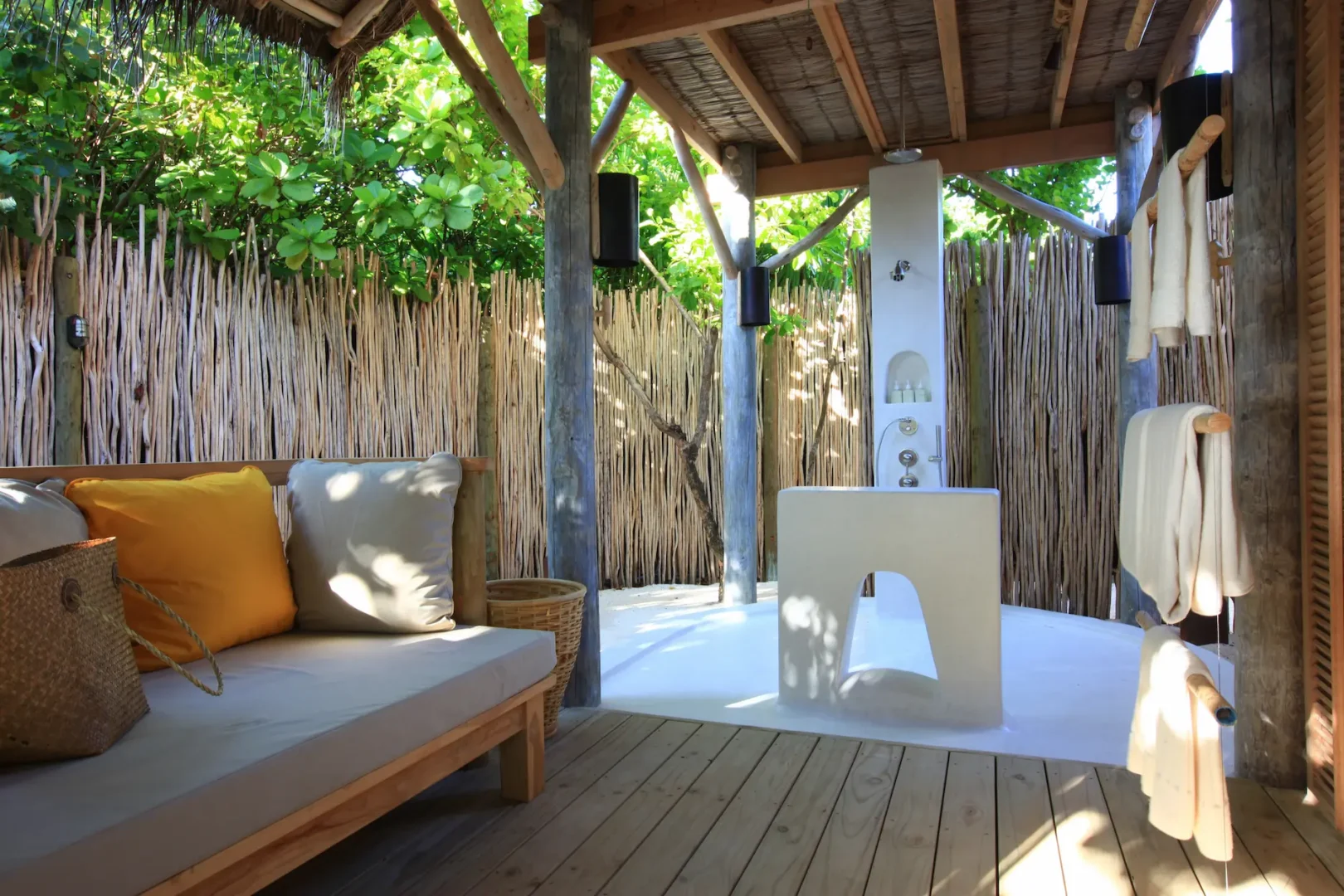 six senses laamu maldives lagoon beach villa with pool bathroom featuring natural textures soft ambient lighting and a calm refined barefoot luxury atmosphere