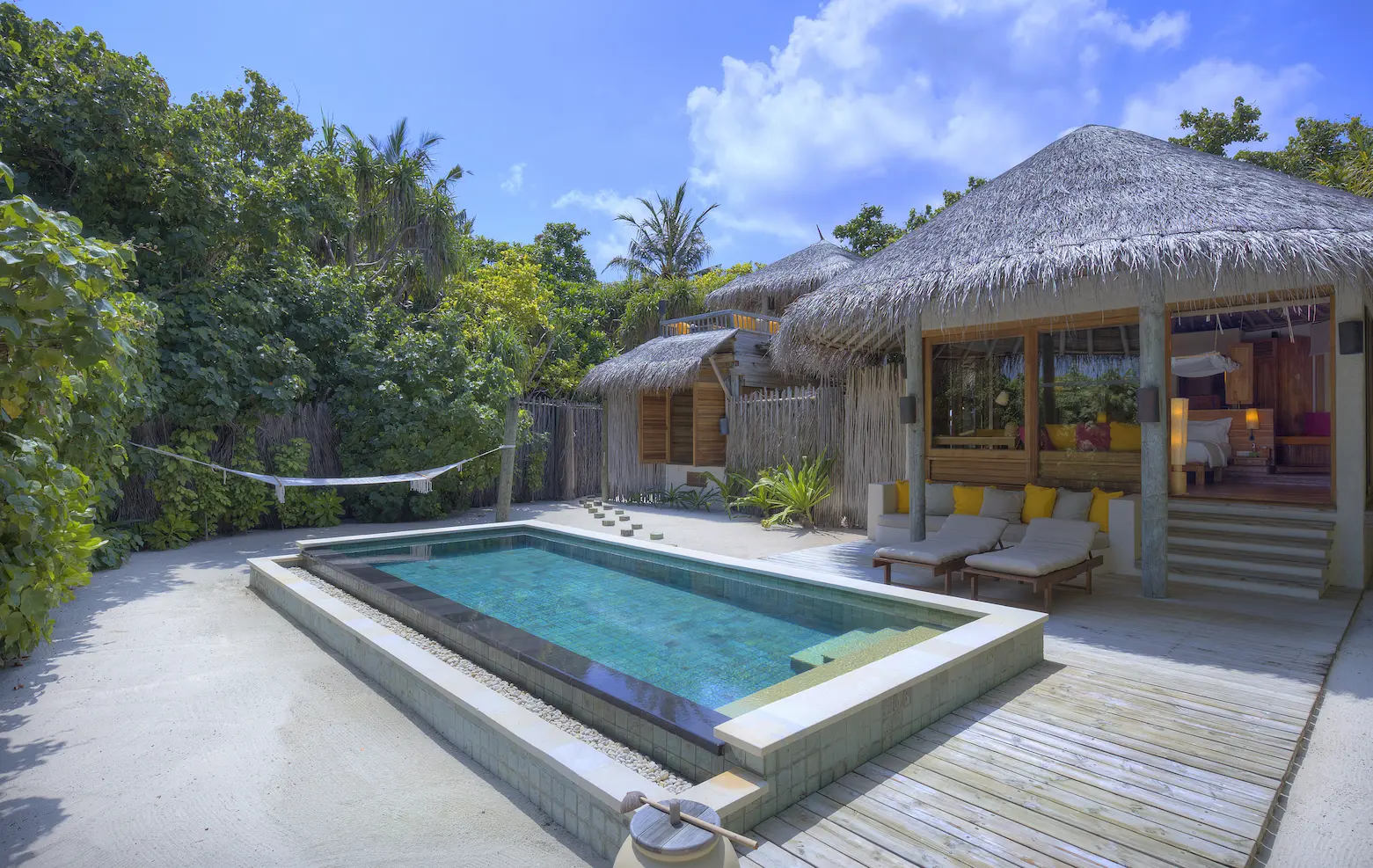 six senses laamu maldives lagoon beach villa with pool exterior surrounded by tropical greenery natural wood design and a calm elevated barefoot luxury atmosphere