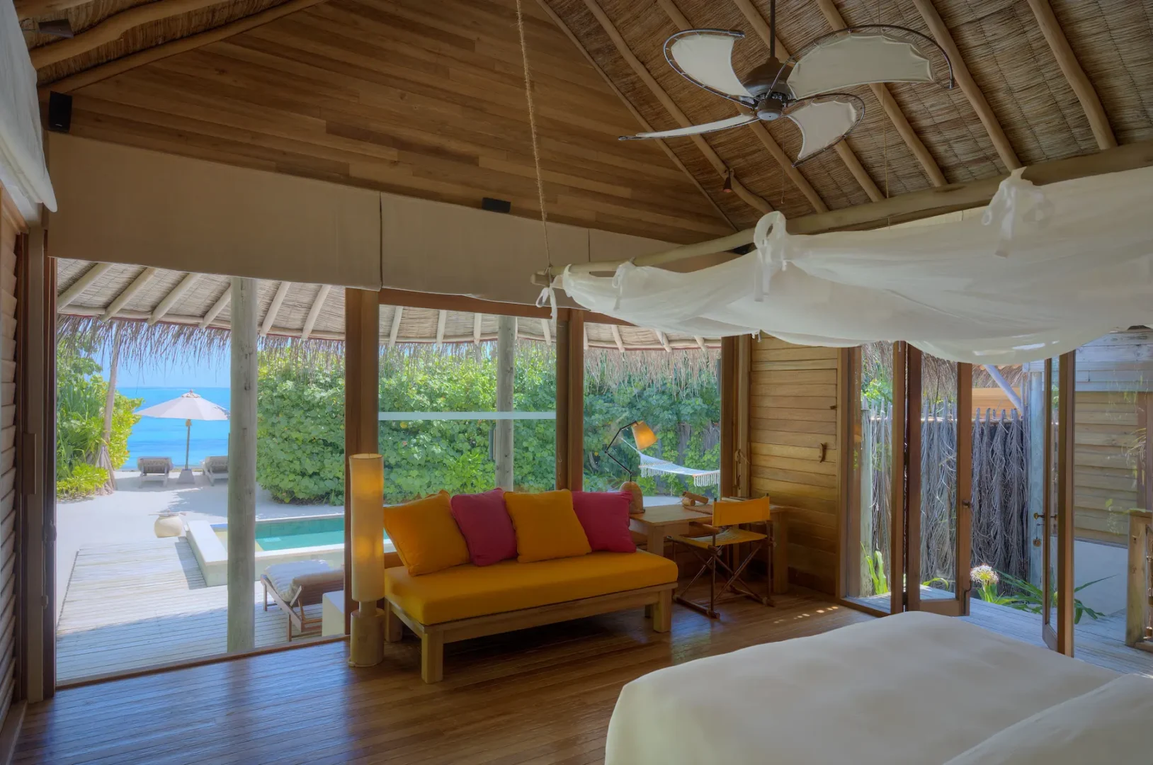 six senses laamu maldives lagoon beach villa with pool garden view surrounded by tropical greenery natural wood design and a calm elevated barefoot luxury atmosphere