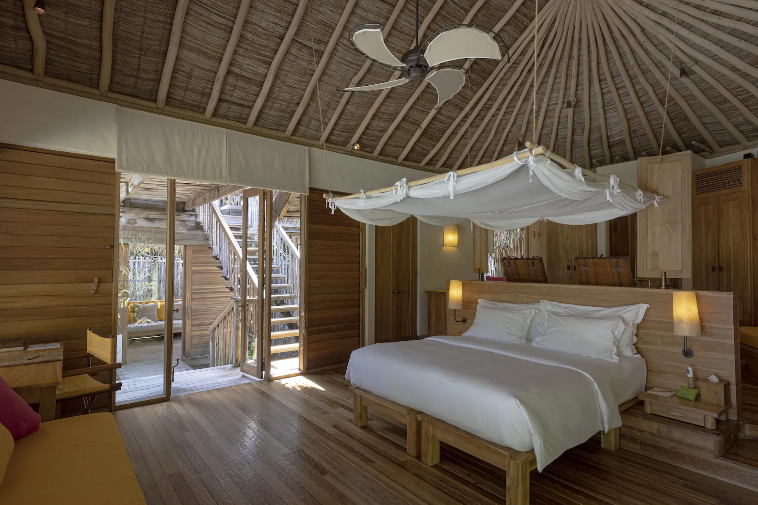 six senses laamu maldives lagoon beach villa with pool interior bed featuring natural textures soft warm lighting and a calm refined barefoot luxury atmosphere