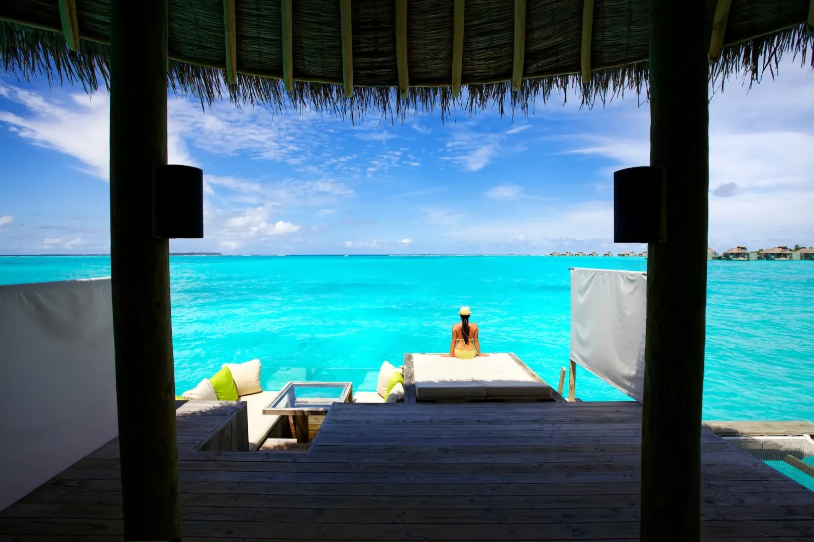 six senses laamu maldives ocean water villa with expansive lagoon views natural wood finishes and a calm elevated barefoot luxury feel
