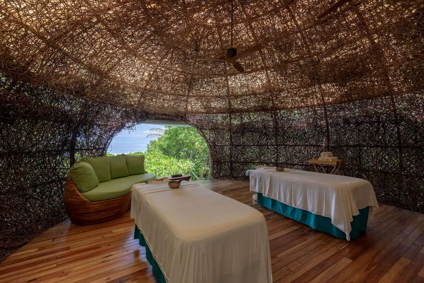 six senses laamu maldives spa treatment room nest surrounded by natural textures tropical greenery and a serene elevated barefoot luxury wellness atmosphere