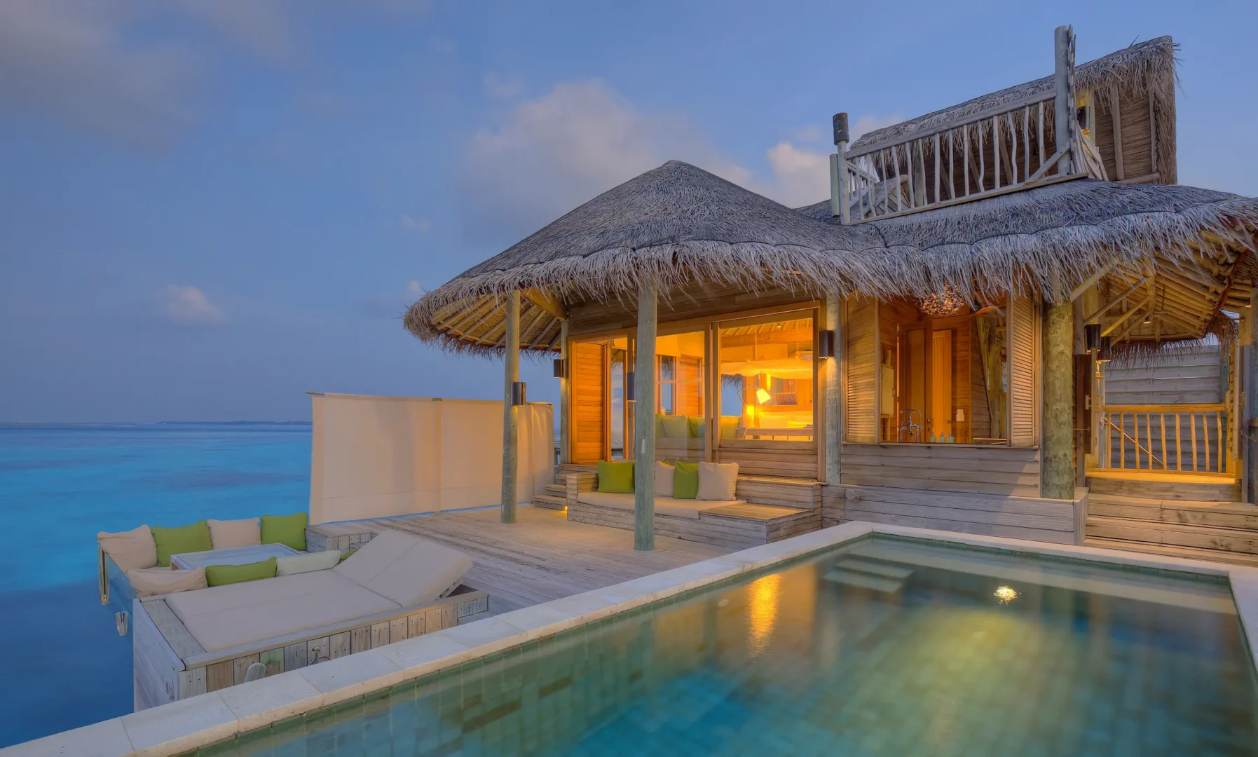 six senses laamu maldives water villa with pool exterior overlooking the lagoon with natural wood architecture and a serene elevated barefoot luxury atmosphere