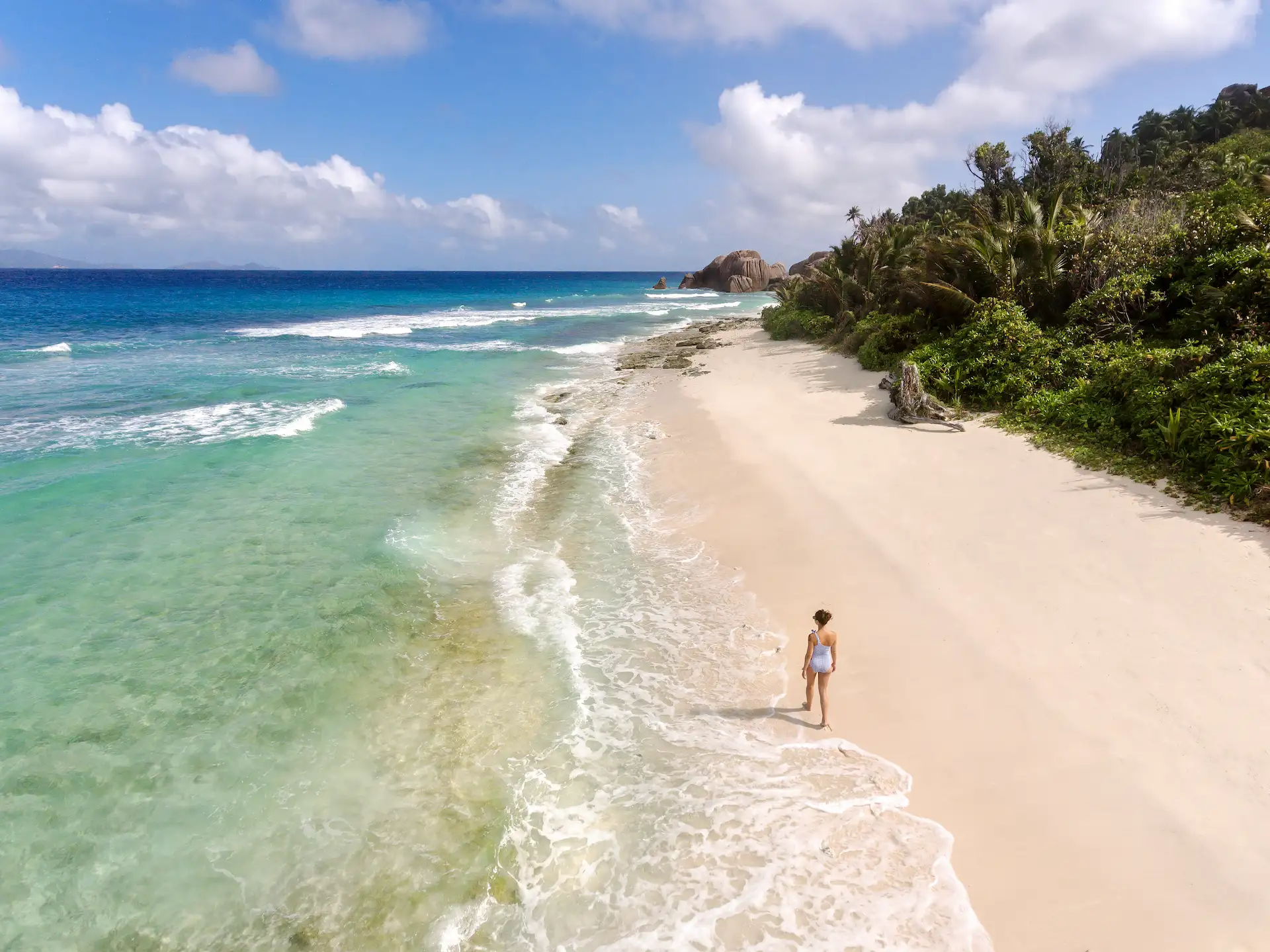 grand anse beach at six senses seychelles with white sand and clear blue ocean