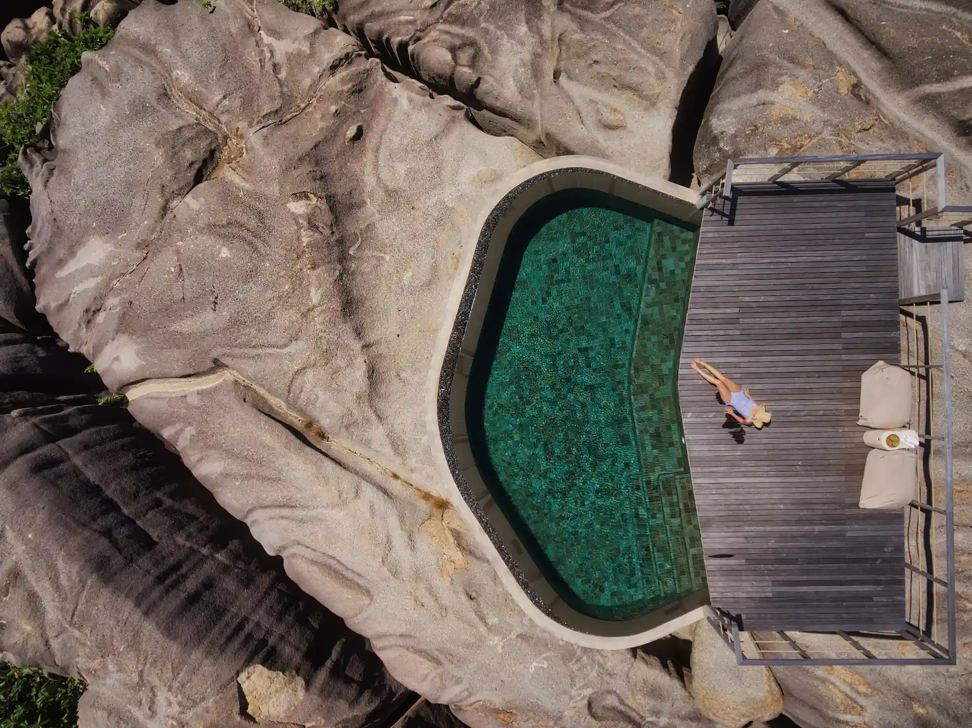 aerial view of spa pool at six senses seychelles with ocean and surrounding landscape