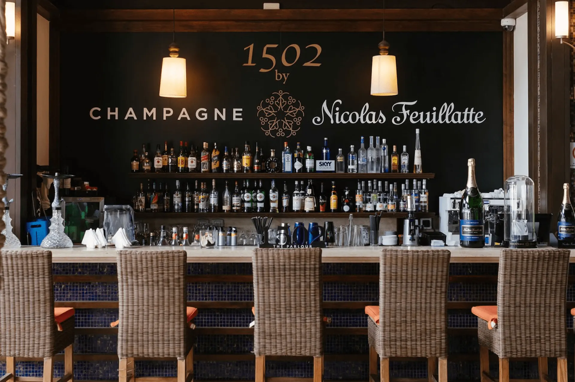 1502 Bar in Seychelles, featuring a stylish indoor bar with ambient lighting, seating, and a selection of drinks.