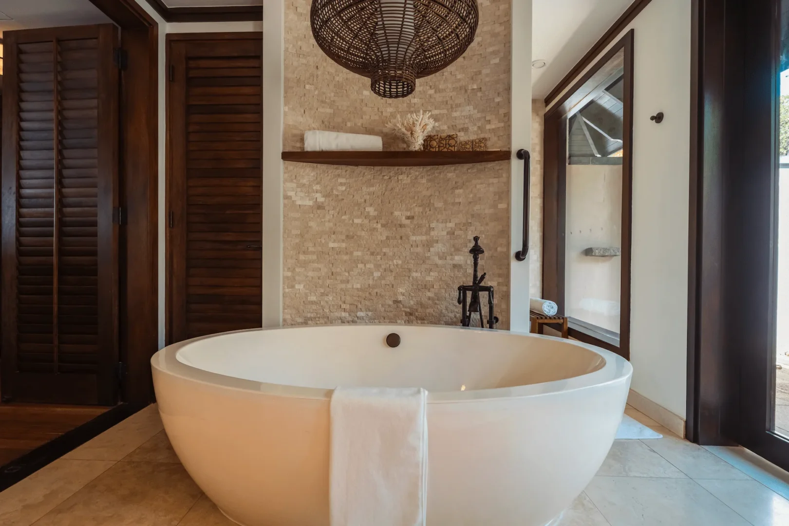 Bathroom of a grand beach pool villa in Seychelles featuring a spacious bathtub and modern fittings