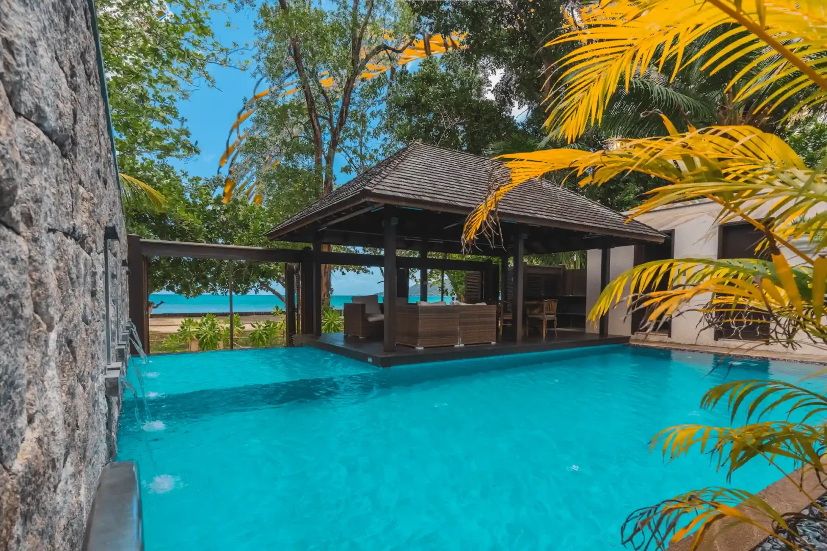"Private pool of a grand beach pool villa in Seychelles, surrounded by sun loungers