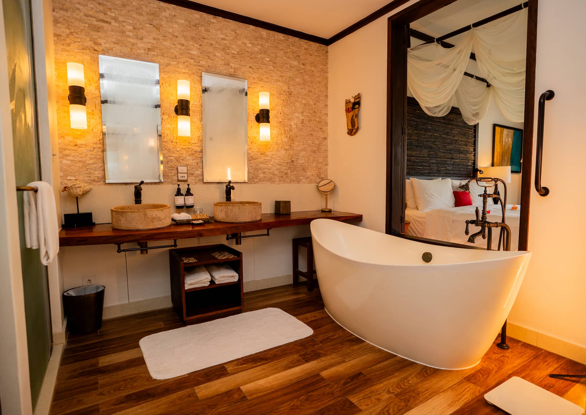 Bathroom of a junior suite with balcony in Seychelles, featuring modern fixtures, a bathtub, and elegant tropical decor.