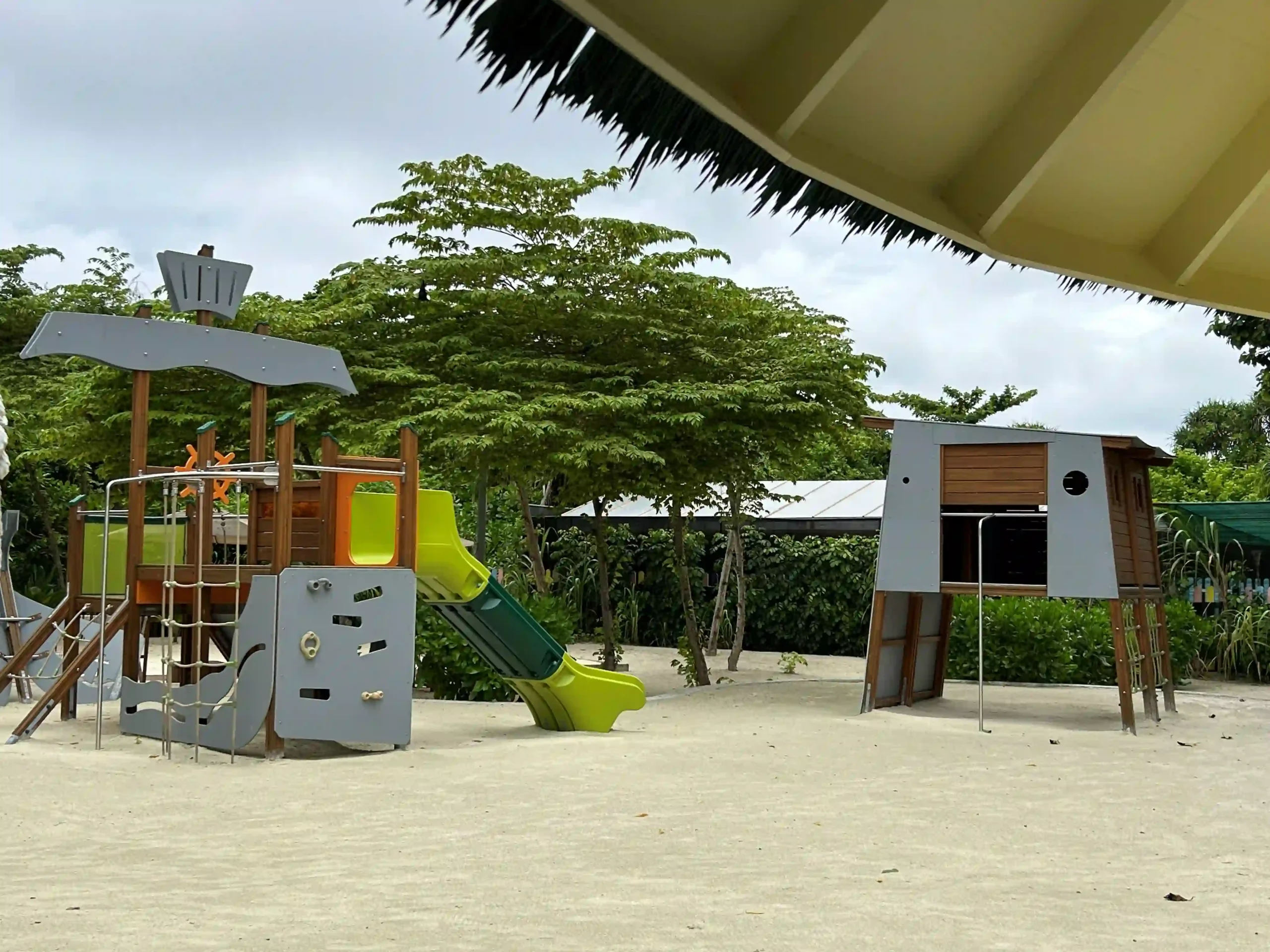 sun siyam maldives kids club play area with slides and colorful playground