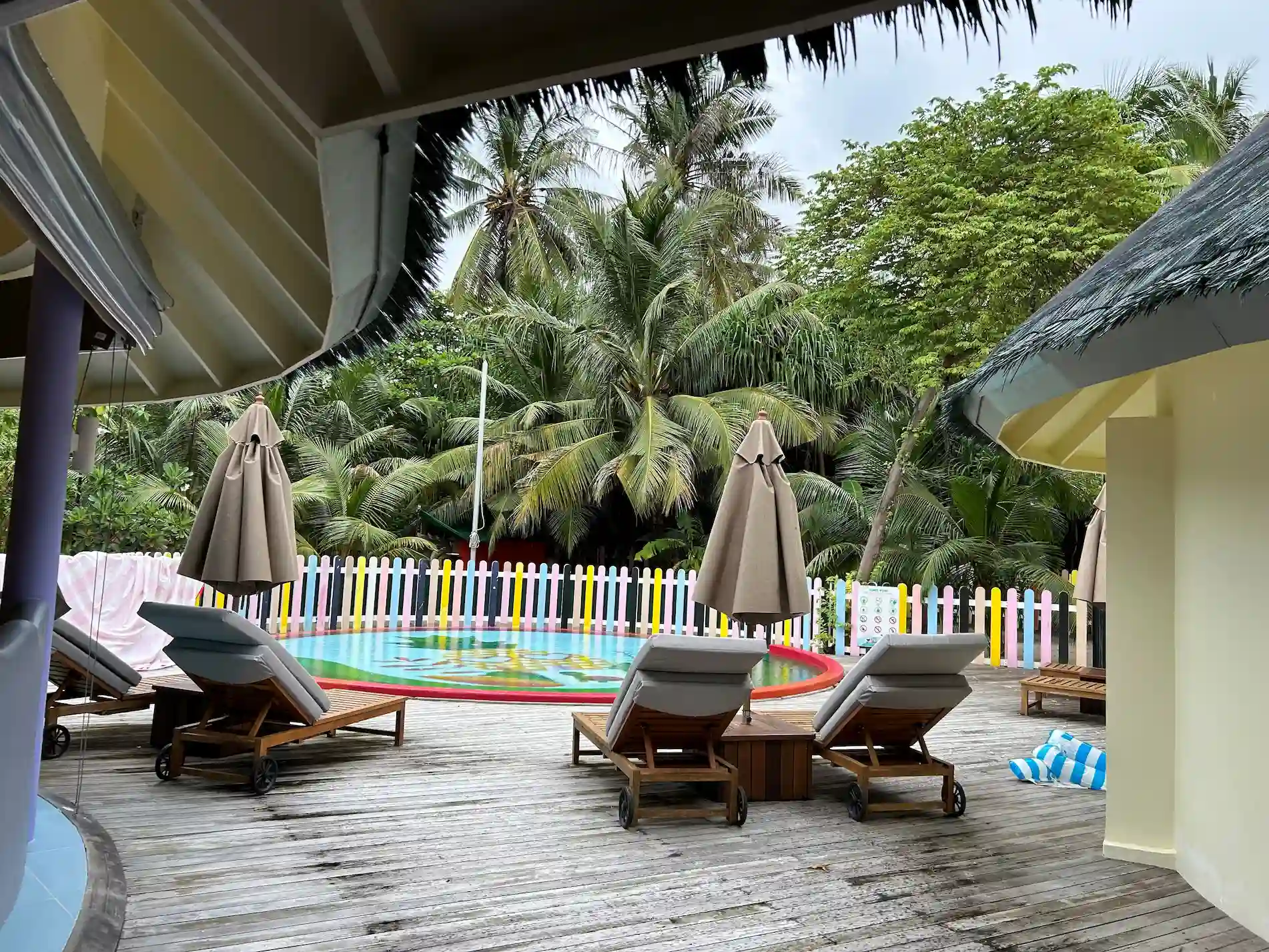 sun siyam maldives kids club pool with children playing and lounge chairs