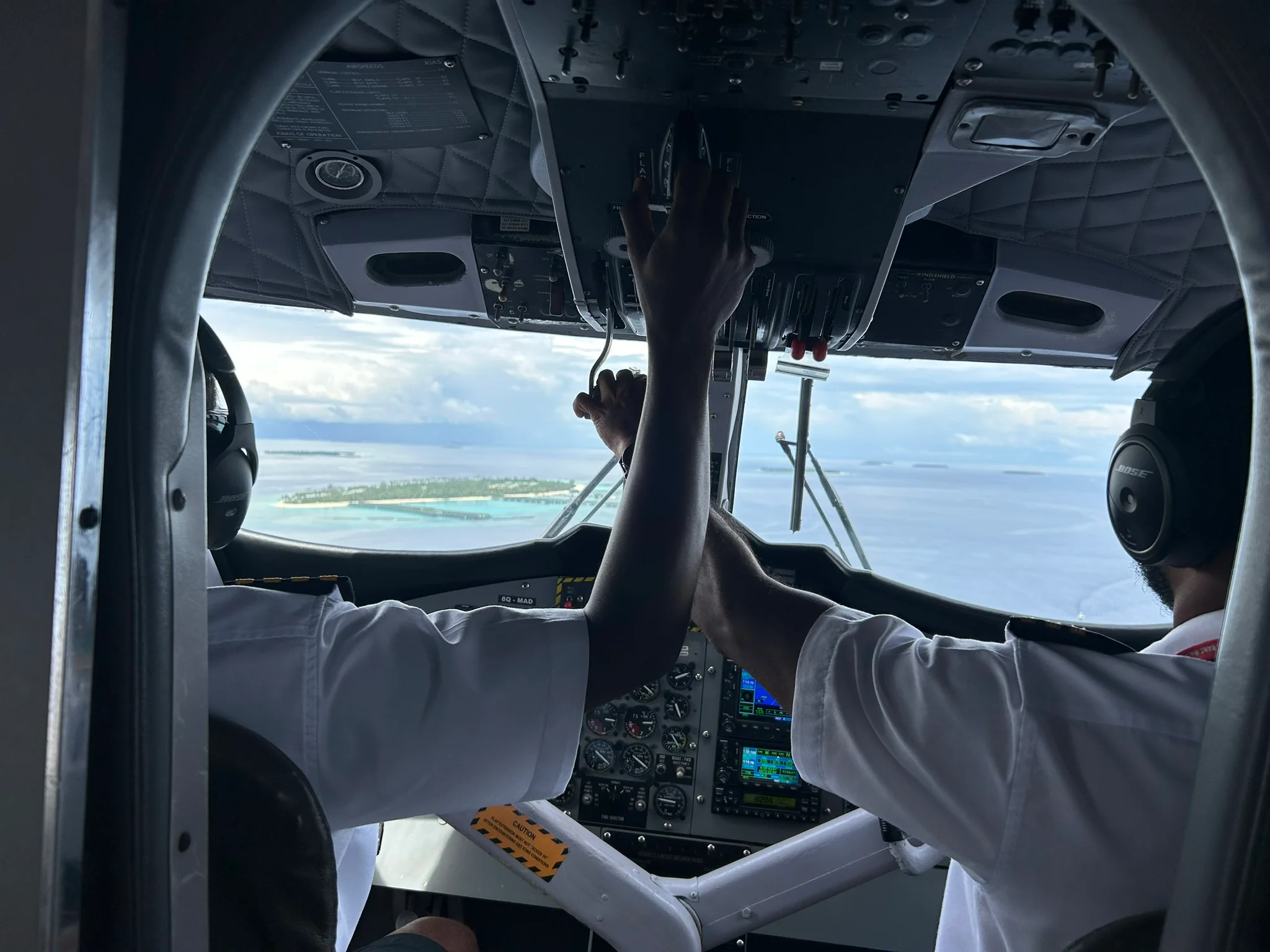 sun siyam maldives pilot standing next to seaplane at airstrip