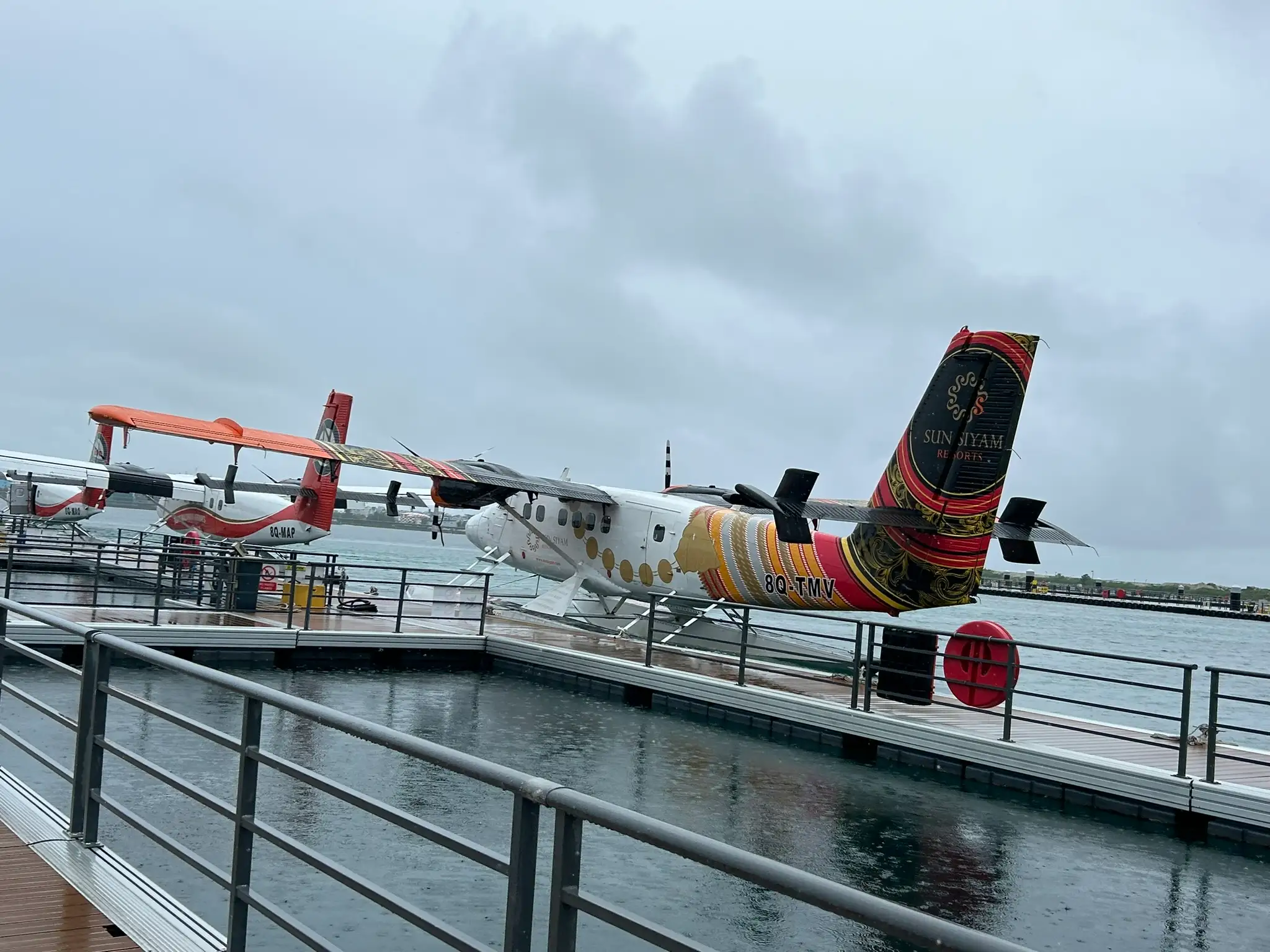 sun siyam maldives seaplane flying over turquoise ocean and islands