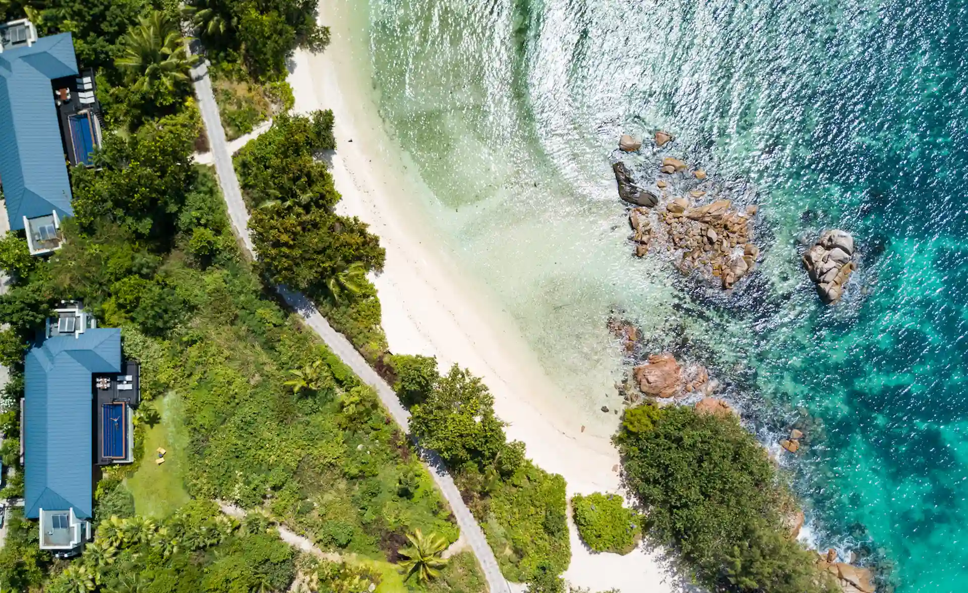 birds eye view of two bedroom beachfront pool villa in seychelles showing private pool, white sand beach, and turquoise ocean