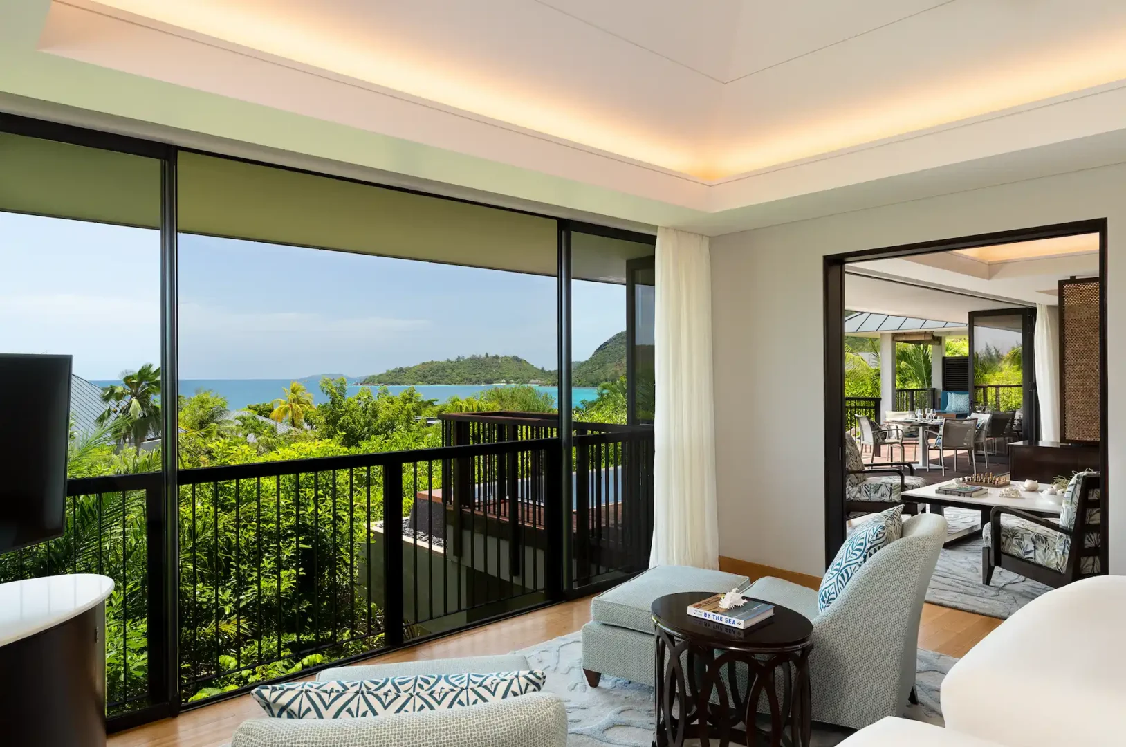 lounge area view of two bedroom ocean pool villa in seychelles with seating and ocean view