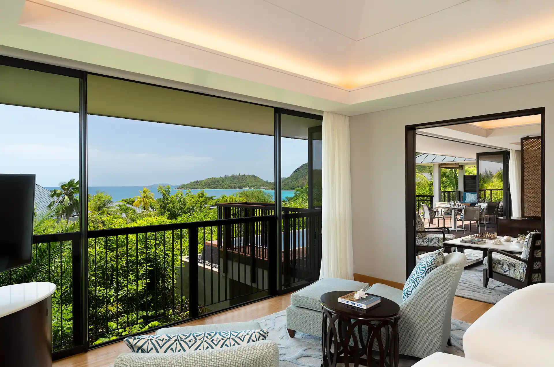 lounge area view of two bedroom ocean pool villa in seychelles with seating and ocean view