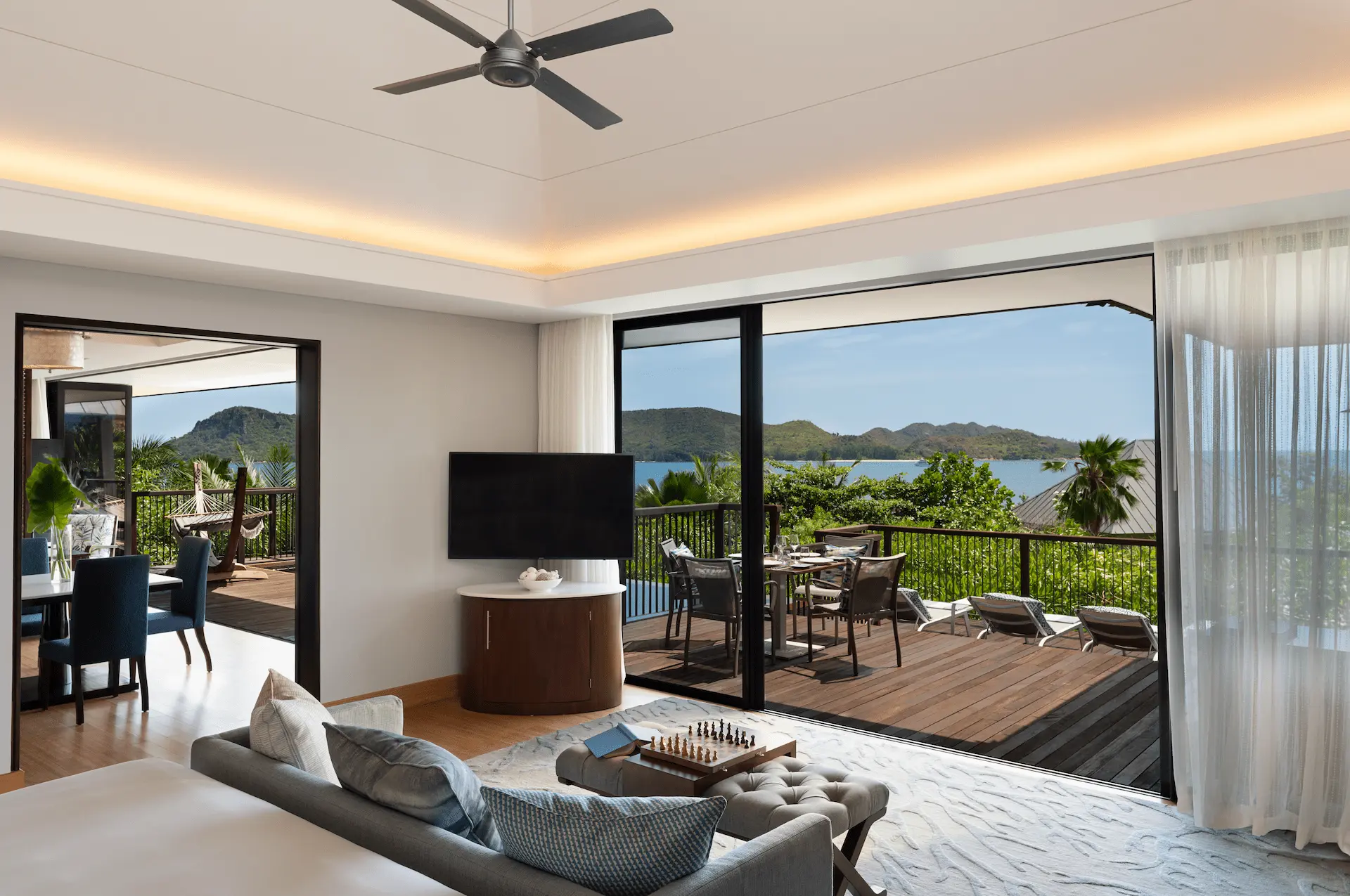 living area with tv in two bedroom ocean pool villa in seychelles with ocean view and seating area