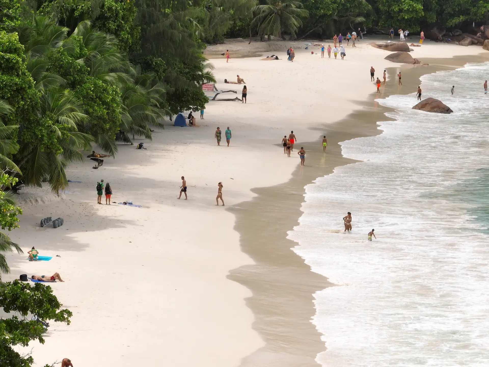beach view during a cruise with Variety Cruises in the Seychelles featuring white sand, clear turquoise waters, and tropical island scenery