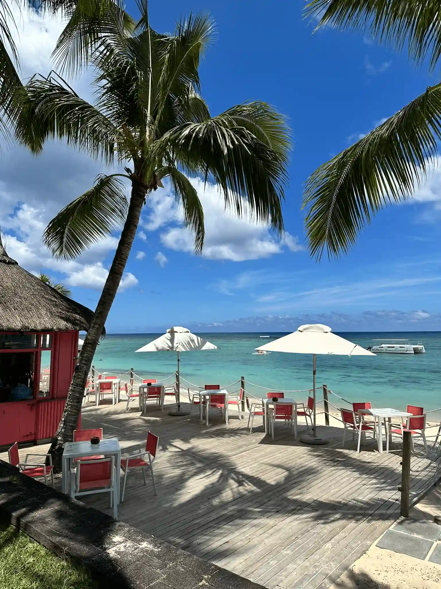 victoria mauritius beach bar with seating umbrellas and ocean view